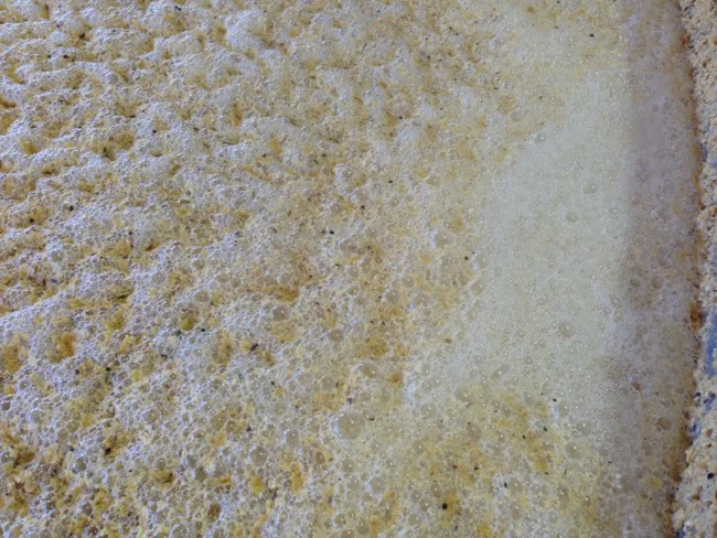 As the yeast works converting the sugars from the grain into alcohol, sometimes violent eruptions of carbon dioxide from the bottom of the tank.