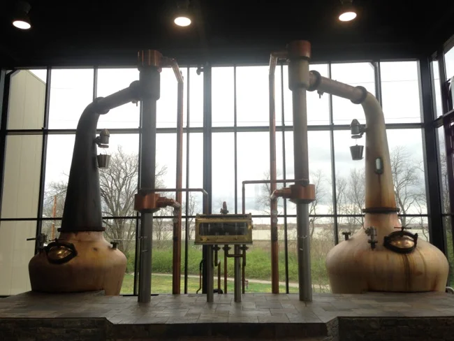 The double pot stills in the new Town Branch distillery. Mash is cooked in one, cooled in tanks below the floor, then pumped into the second still to be distilled again before being barreled.