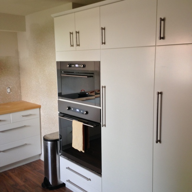 The right wall of our kitchen. Cabinets are 84" tall and feature plenty of room for pantry and dish ware.