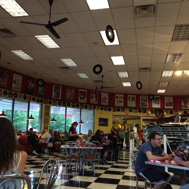The walls are decorated with classic movie posters and album covers