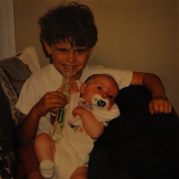 This is a picture of Christopher holding Chelsea. He was so excited to have a little sister he grinned for the first three months. They grew to have a big brother/little sister-love/hate relationship where he could pick on her all he wanted but nobody else was allowed that privilege. 