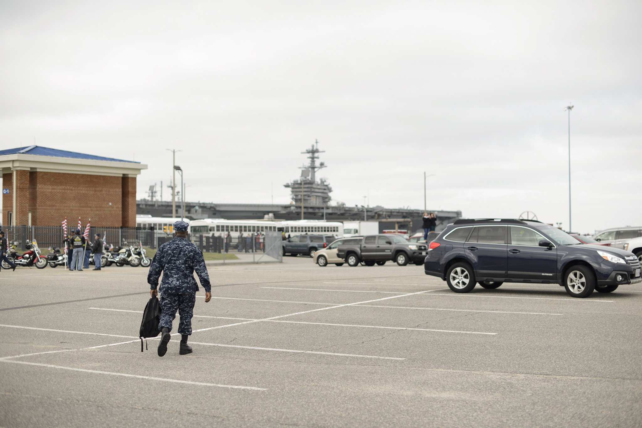 A solitary soldier walks towards his ship | USS Truman naval military homecoming | Maria Grace Photography