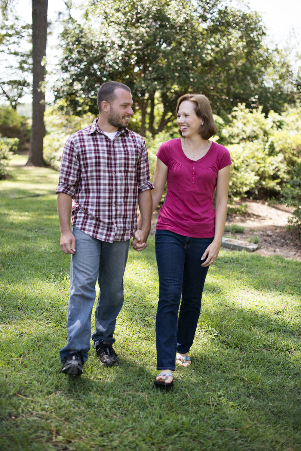 Husband and wife walk hand-in-hand at family portraits in Portsmouth, Virginia