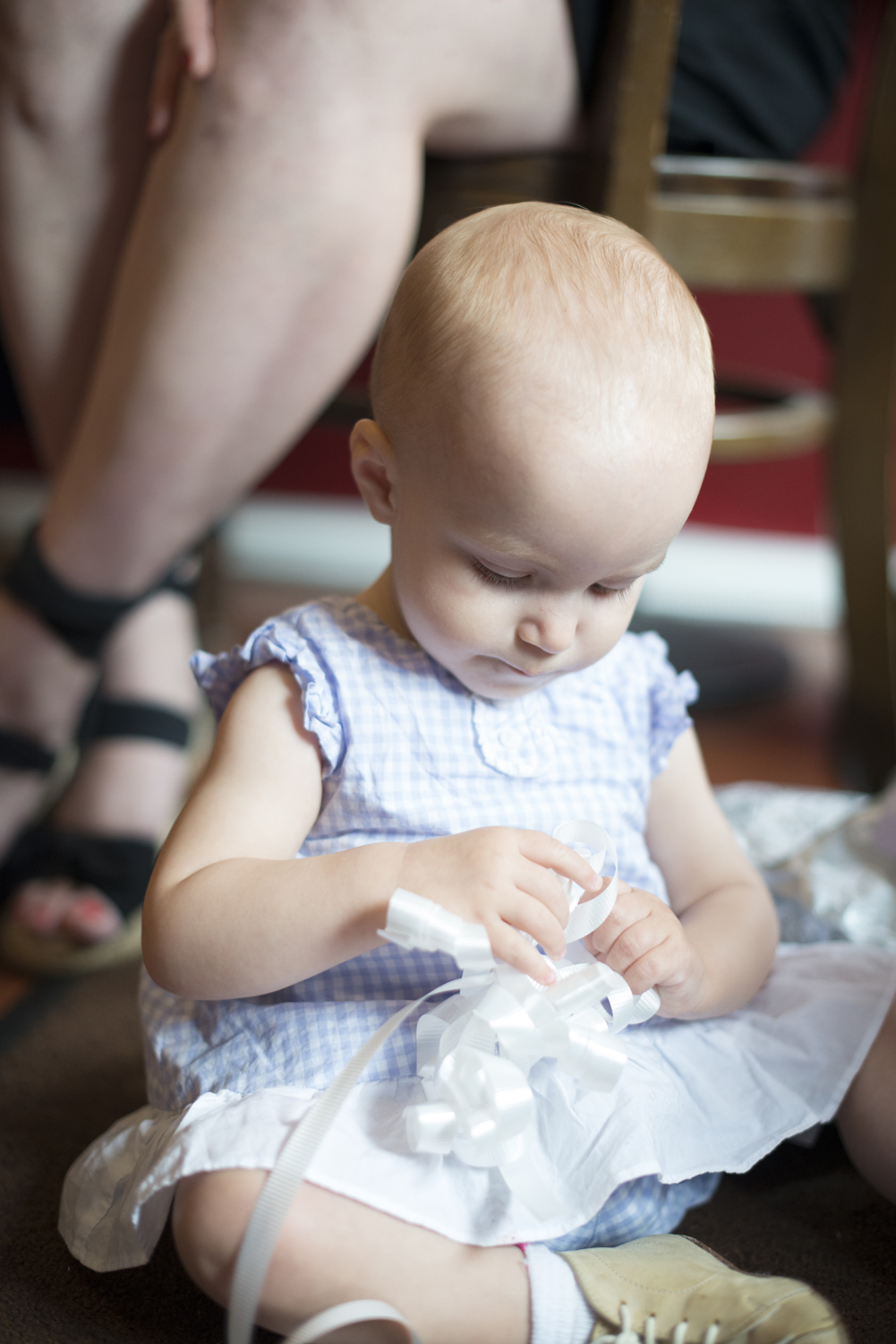 Baby in a gingham blue and white dress