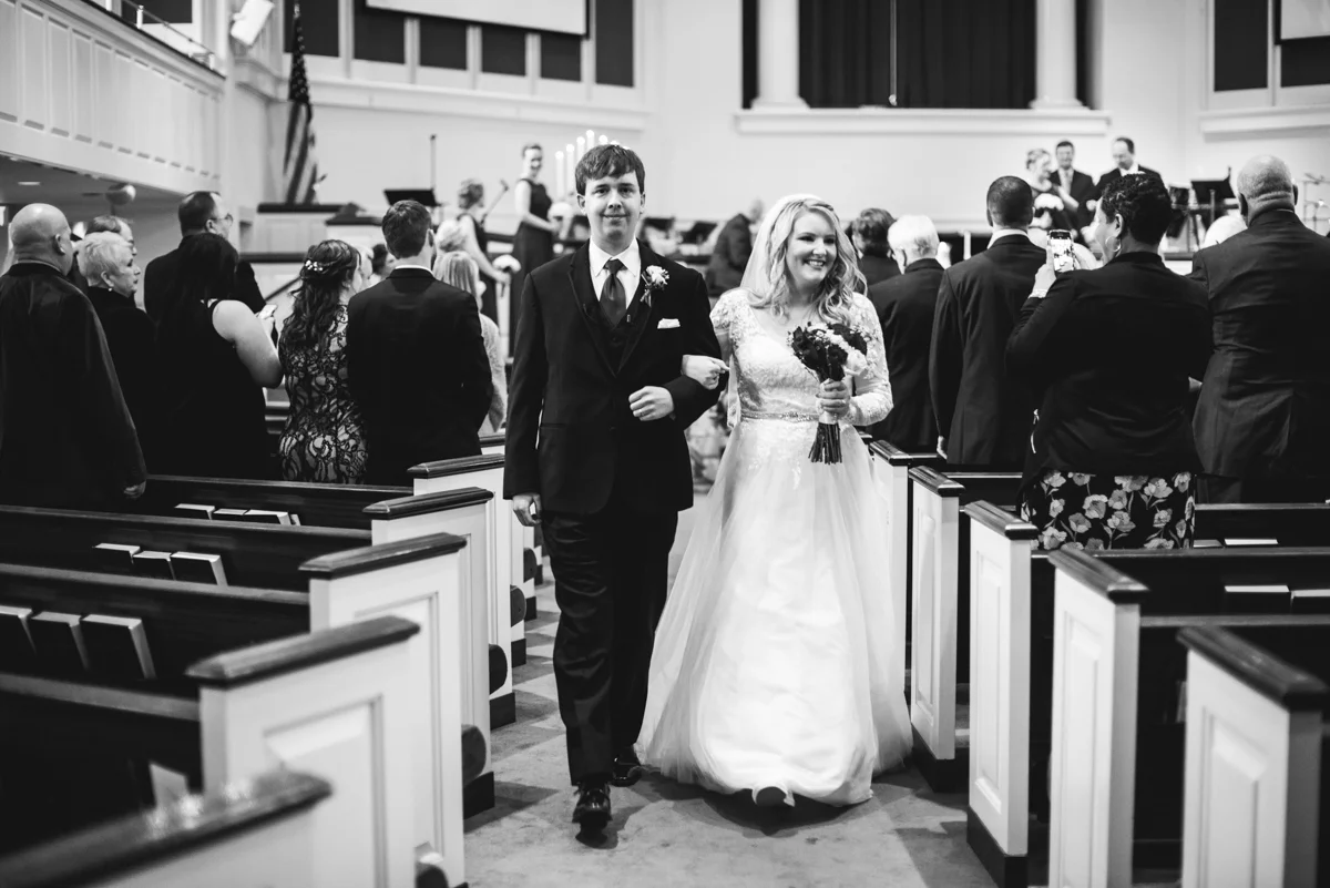 Burgundy and Blush Winter Wedding | Bride and groom recessional