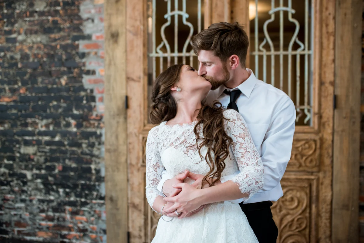 Elegant and Intimate Winery Wedding | Bride and groom portraits with exposed brick