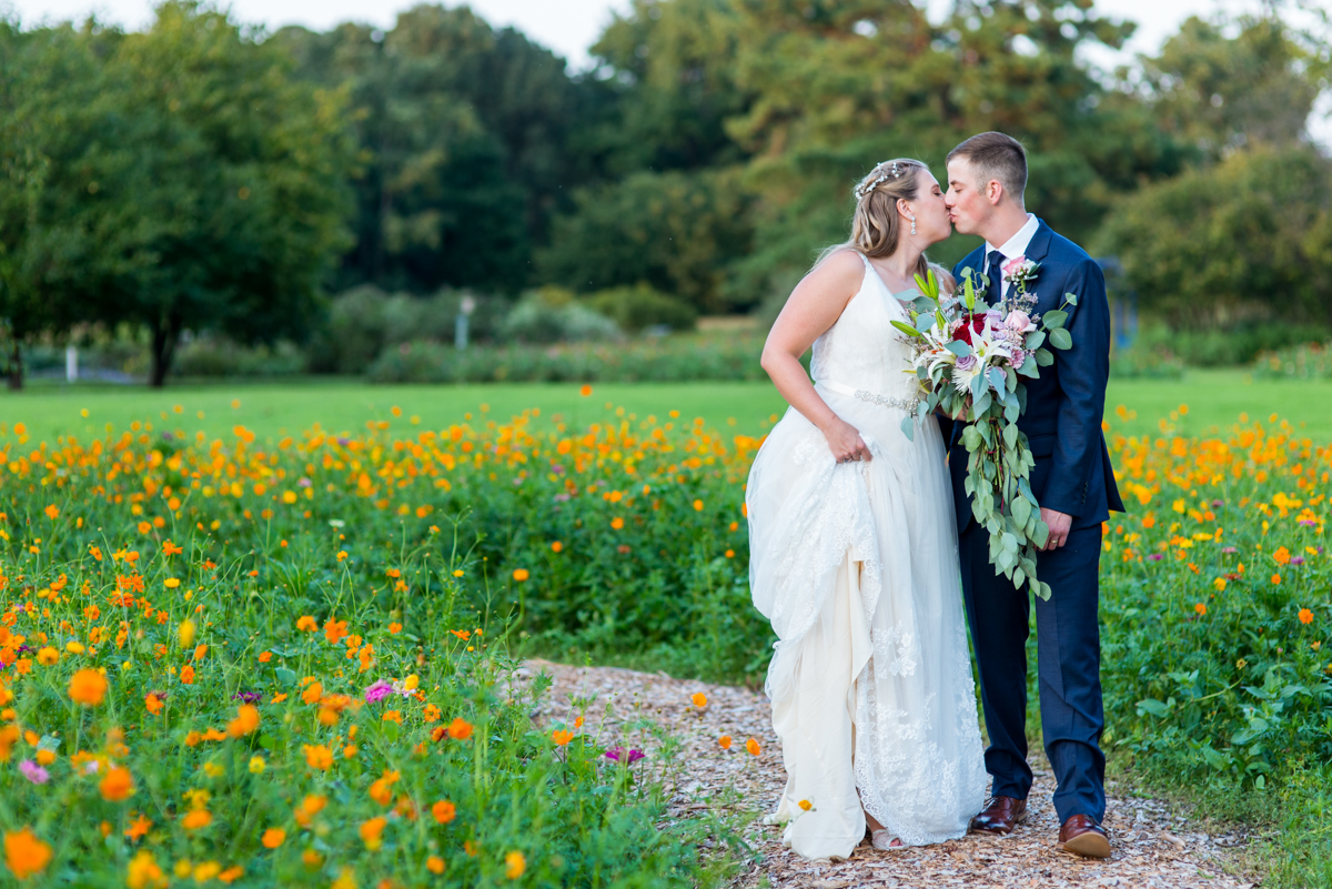 Bright Fall DIY Wedding | Bride and groom pictures in wildflower field