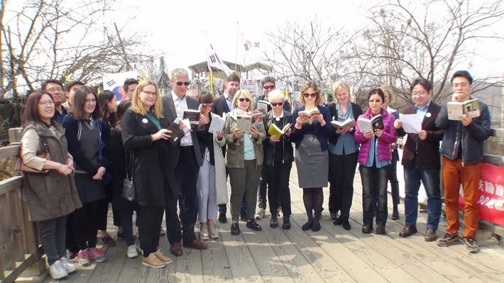 The recent reading from North Korean author Bandi’s ‘The Accusation’ on the Bridge of Freedom in the Korean peninsula’s Demilitarized Zone. Image: Provided by Barbara Zitwer