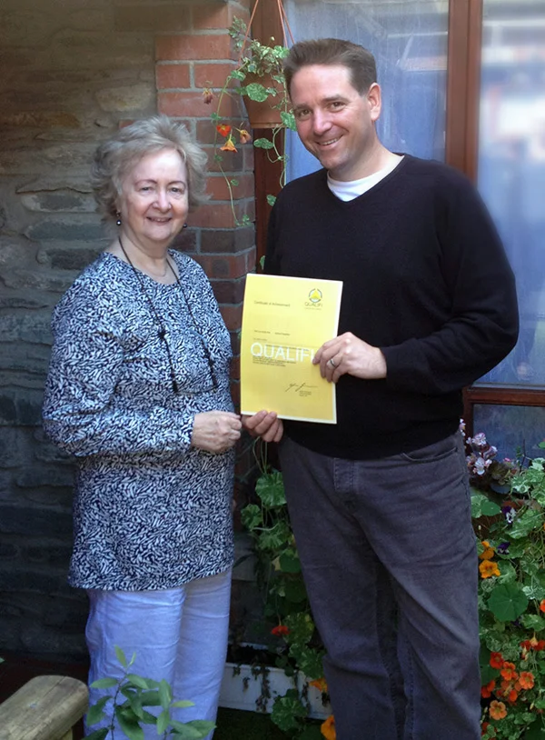 Andrew Fitzpatrick, Counsellor at White Oaks Rehabilitation Centre, receiving his Practitioner's Diploma in CBT from Dr Helena Schlindwein Ph.D. FNCP, Director of CHATS.