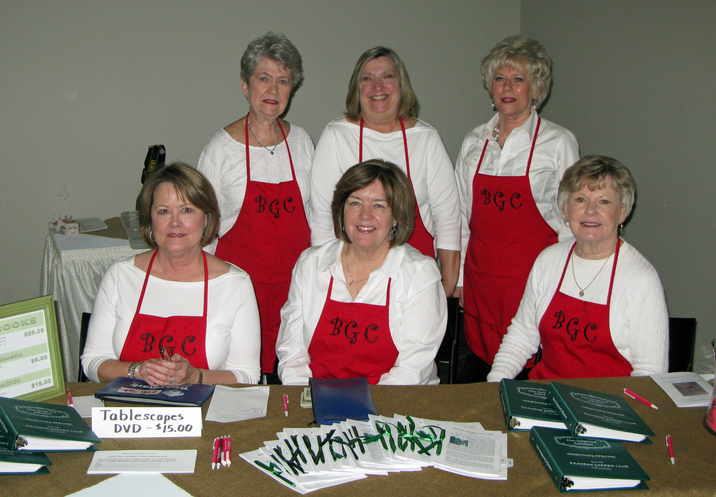 At Brandon Garden Club’s eighth annual Tablescapes Luncheon, guests had opportunities to purchase cookbooks and cookbook inserts, DVDs with over 1,000 photos of the event, and drawing tickets for a fully decorated table that included eight place settings of china, flatware, glasses, linens, and centerpiece. Pictured at the sales table , seated (l to r): Shirley Rupnik, Bobbye Strickland, and Zylpha Champlin. Standing (l to r): Carol Atkinson, Debbie Zischke, and Debbie Robinson.