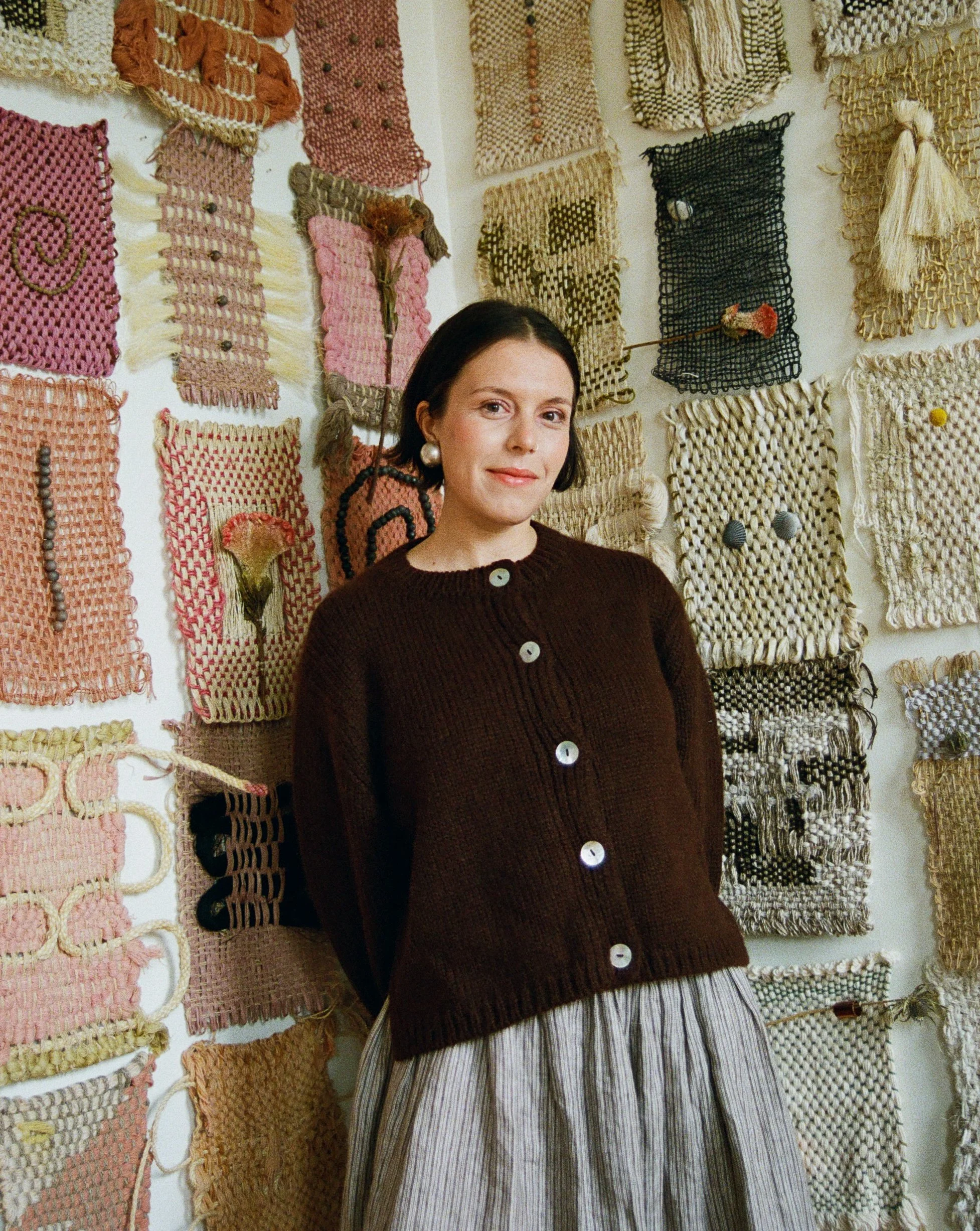 Jessie Mordine Young next to weavings