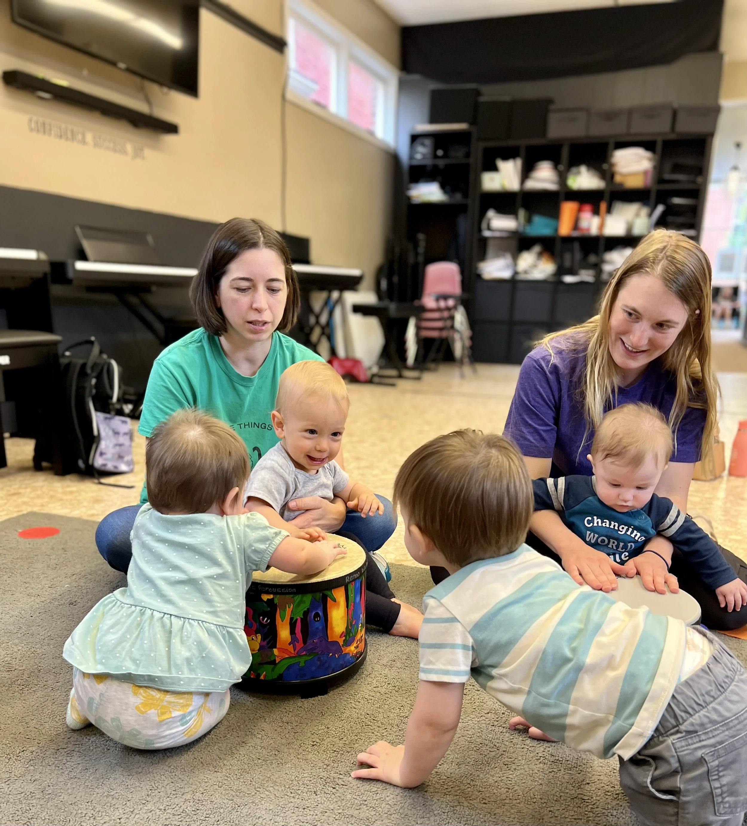 Mothers along with babies and toddlers smile and socialize while exploring instruments during our class in Boyertown PA.