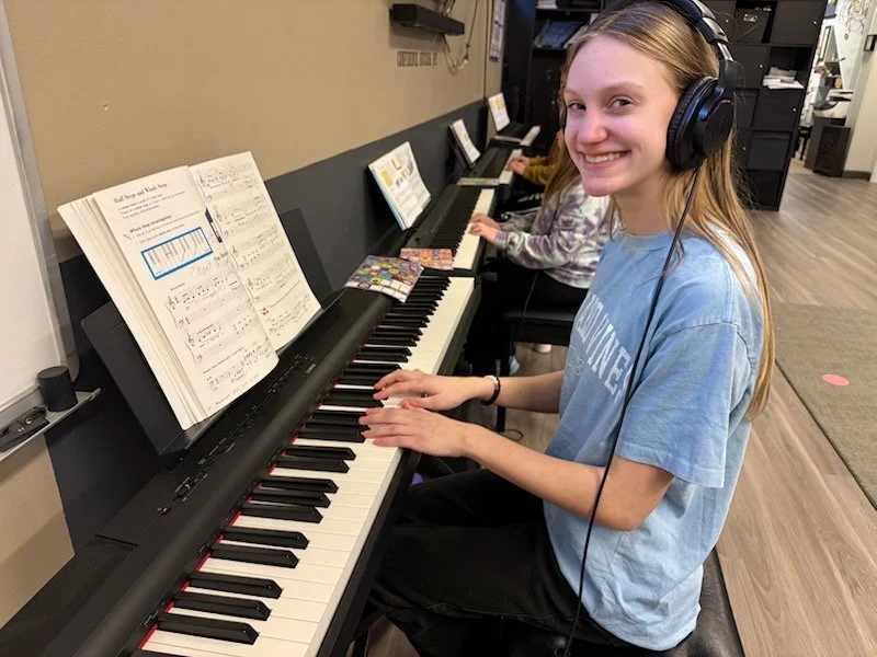 A student wears headphones while practicing at a keyboard during piano class at the the Music Studio of Patricia Keith in Boyertown PA.