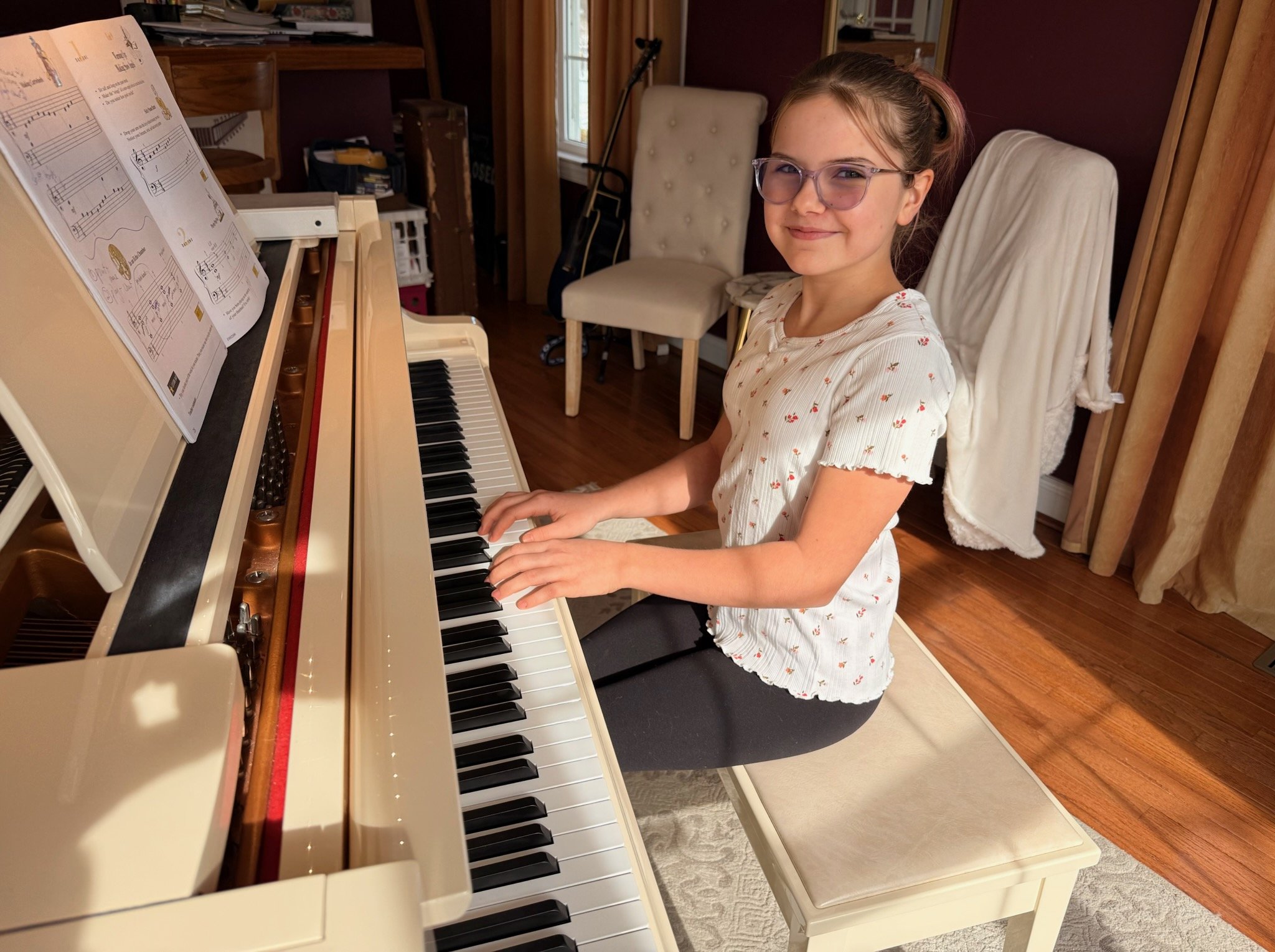 An older student practices at the grand piano at the Music Studio of Patricia Keith