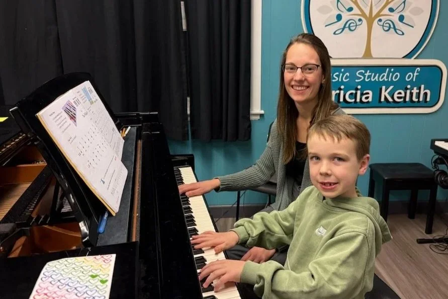 Ms Julia and young piano student grand piano.jpg