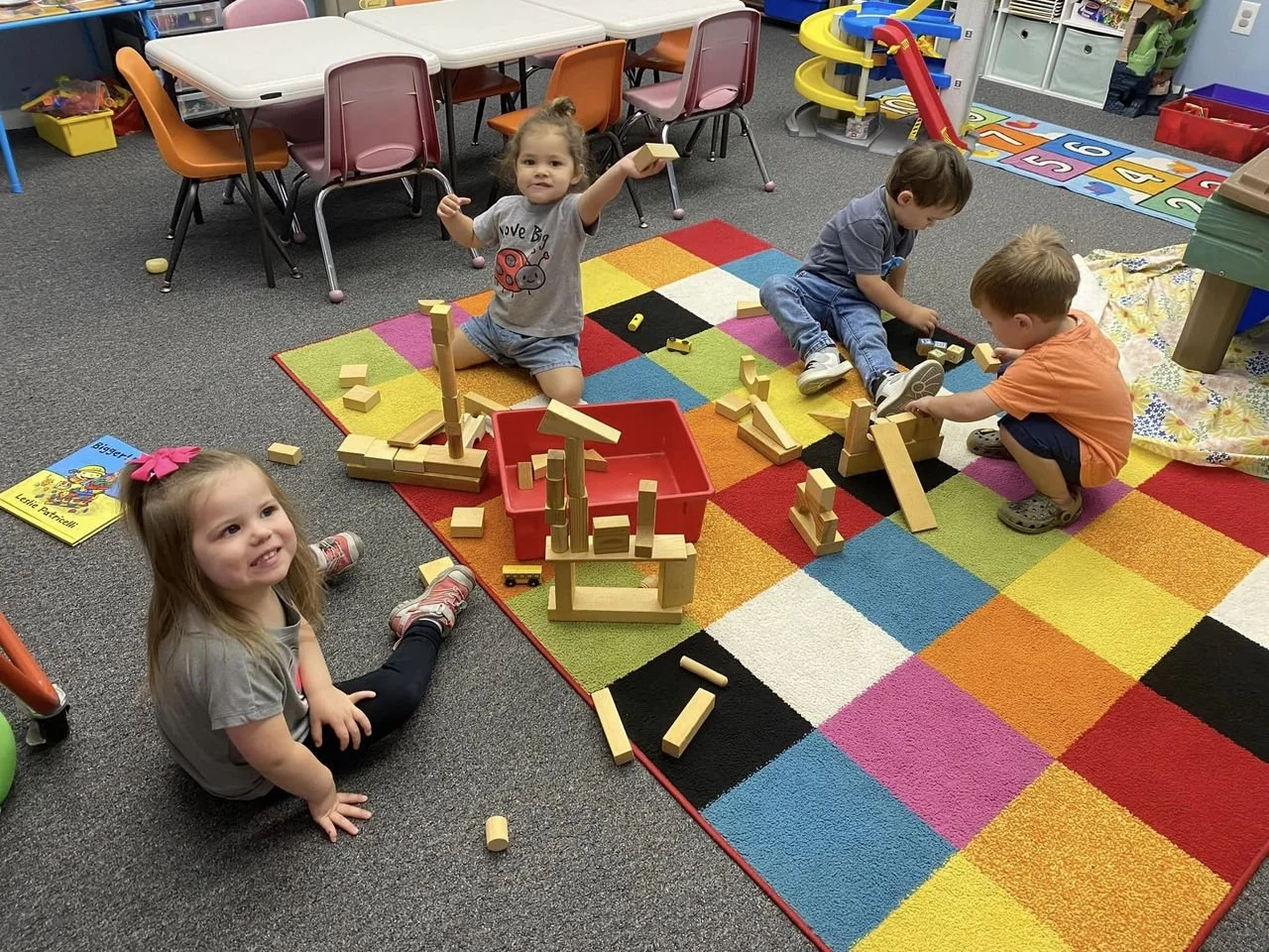 Children play with blocks on the floor during our Busy Bees class at our studio in Boyertown, PA.