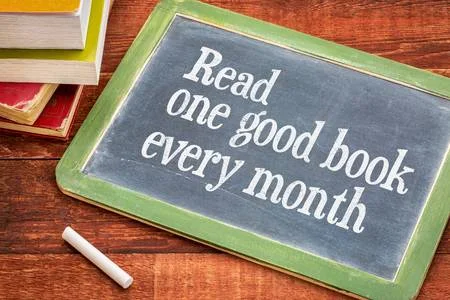 50275540-read-one-good-book-every-month-advice-or-reminder-on-a-slate-blackboard-with-a-white-chalk-and-a-sta.jpg