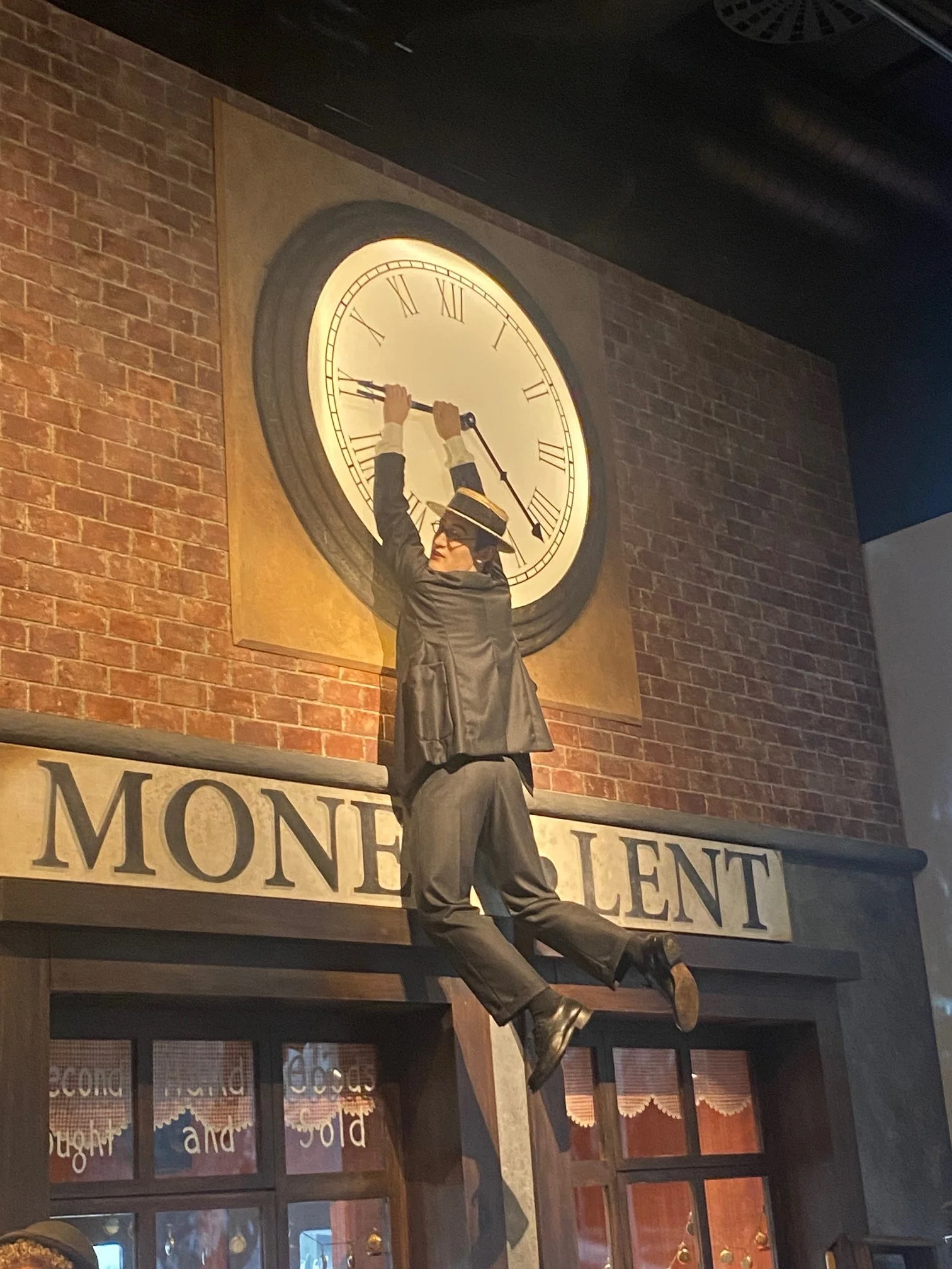 Harold Lloyd hanging on his clock