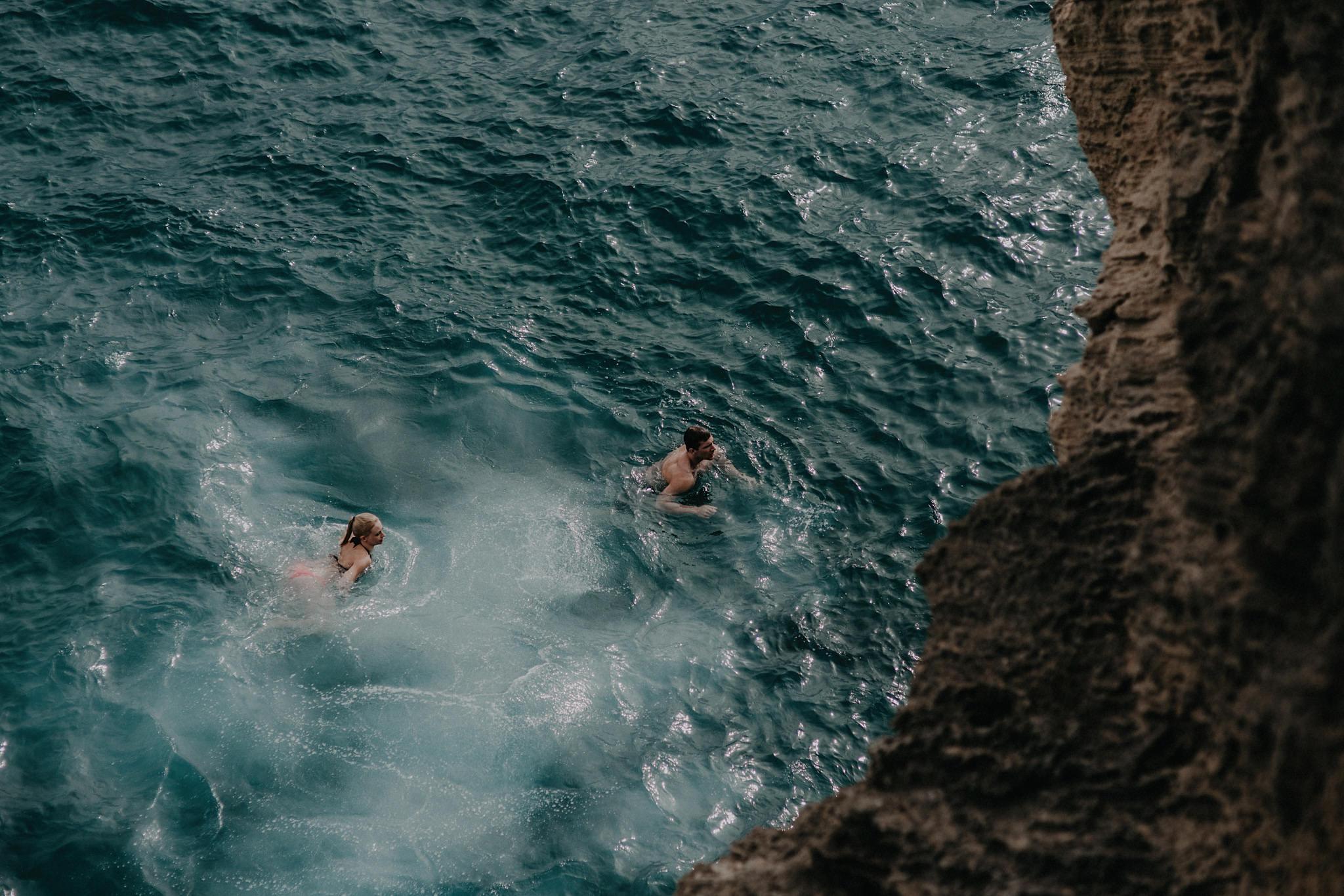 hawaii kauai elopement cliff jumping bride groom swimming photo