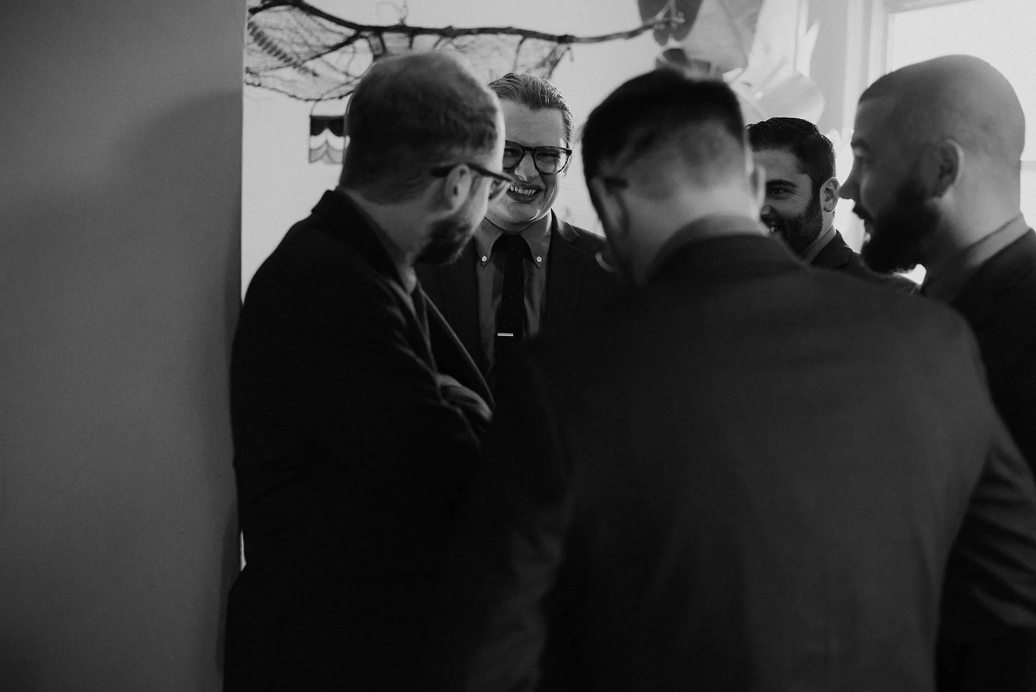 cincinnati warehouse wedding photographer groom groomsmen laughing