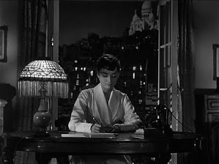 Hepburn's character writing to her father as she begin her journey home from Paris in Sabrina.