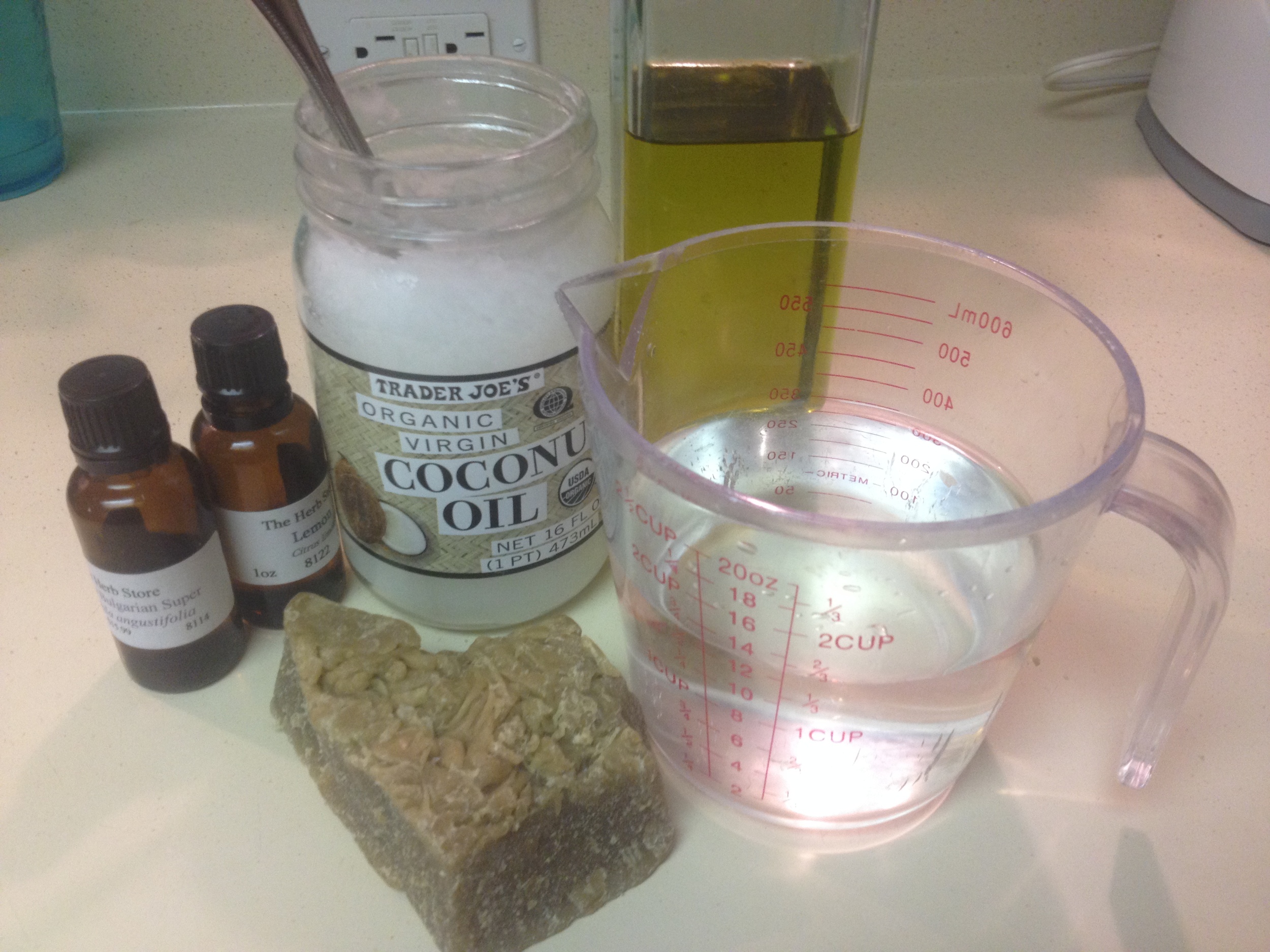 Ingredients from left to right: essential oils, coconut oil, olive oil, distilled water, and beeswax.
