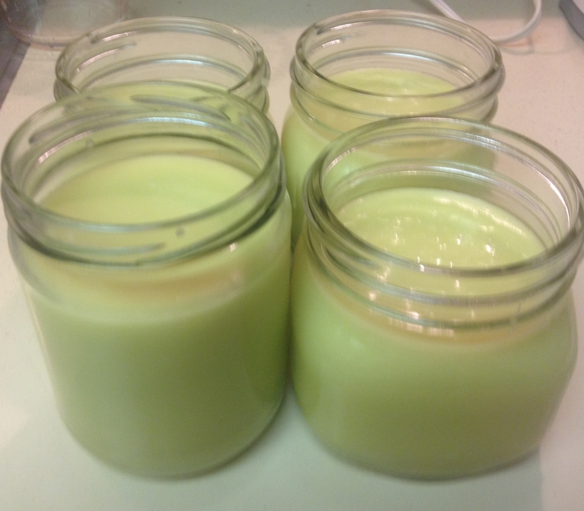 Freshly jarred homemade body butter, cooling.