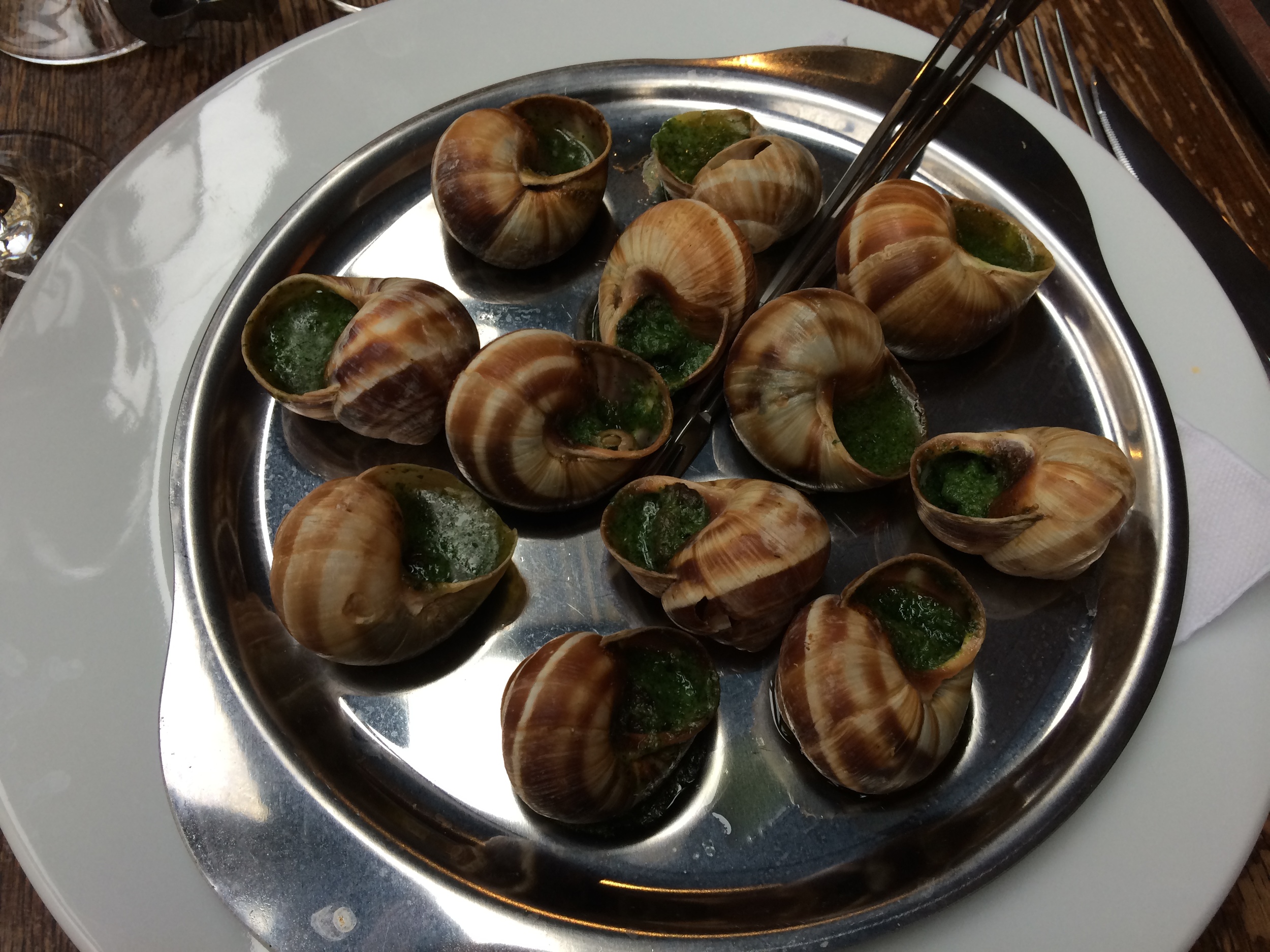 Escargot (snails) cooked in butter and parsley.