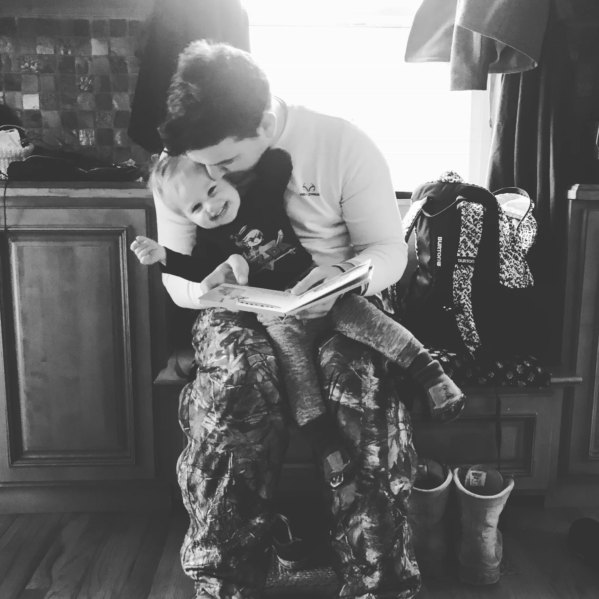 Perfect example. I was doing dishes when this was happening. Trent had just gotten home from hunting and O was elated to see him (as usual). He promptly brought over a book for Dad to read, which also required many kisses and squeezes. This man misses his kids SO much when he's away. I am grateful for his doting, uncensored LOVE for the kids. I stopped - dishes could wait. I needed to hold on to this moment.