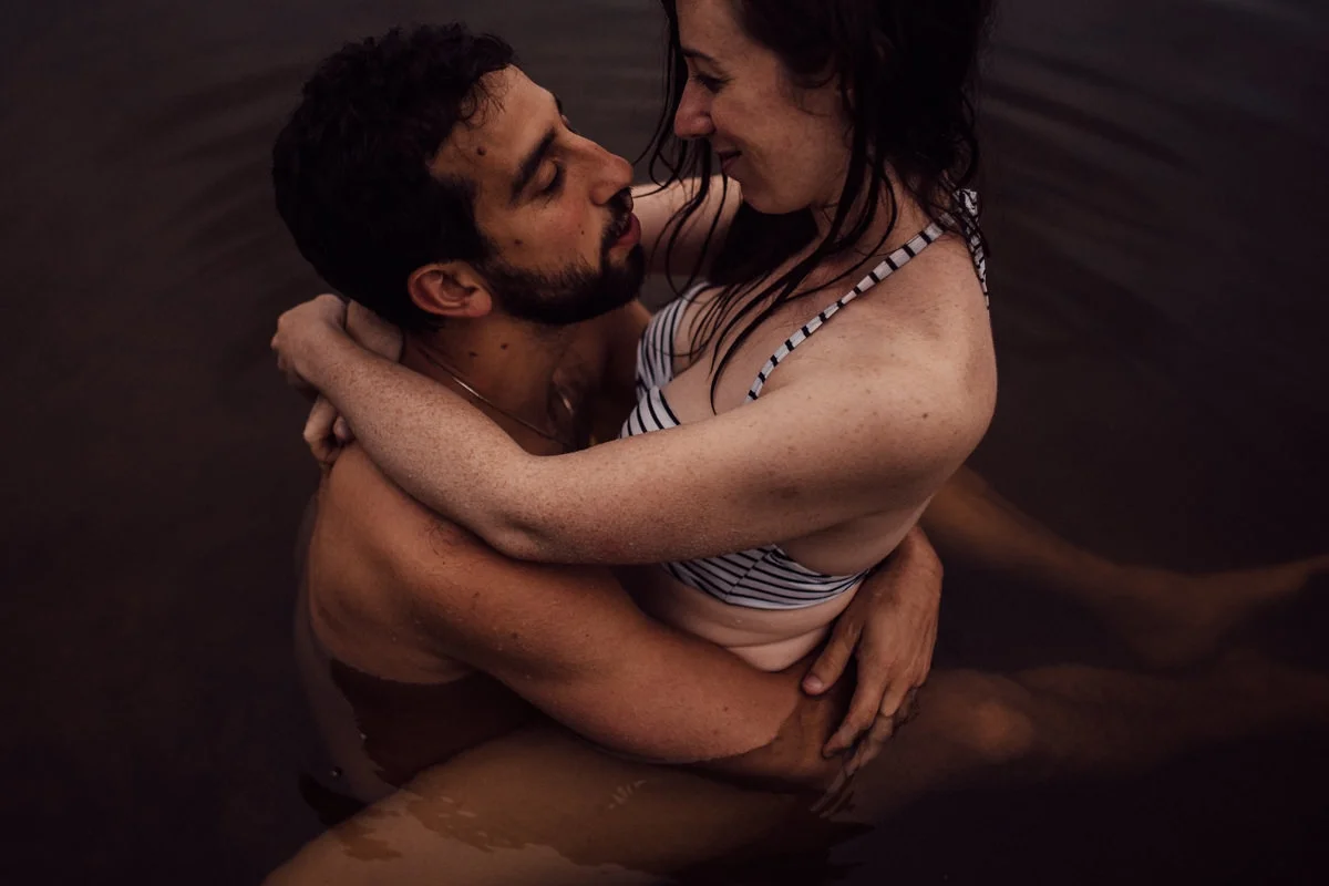 Couple hugging in lake
