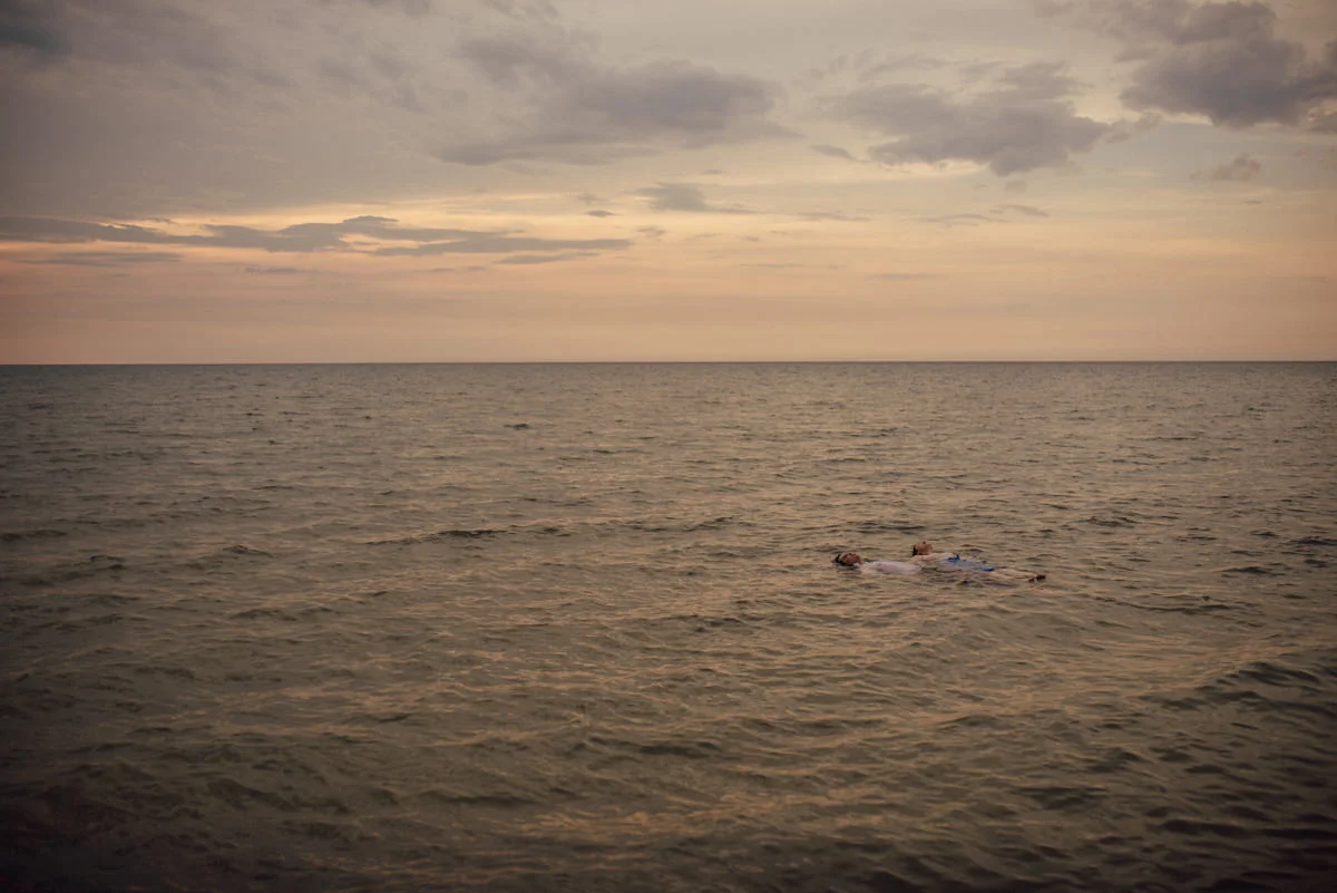 Engaged couple floating above water