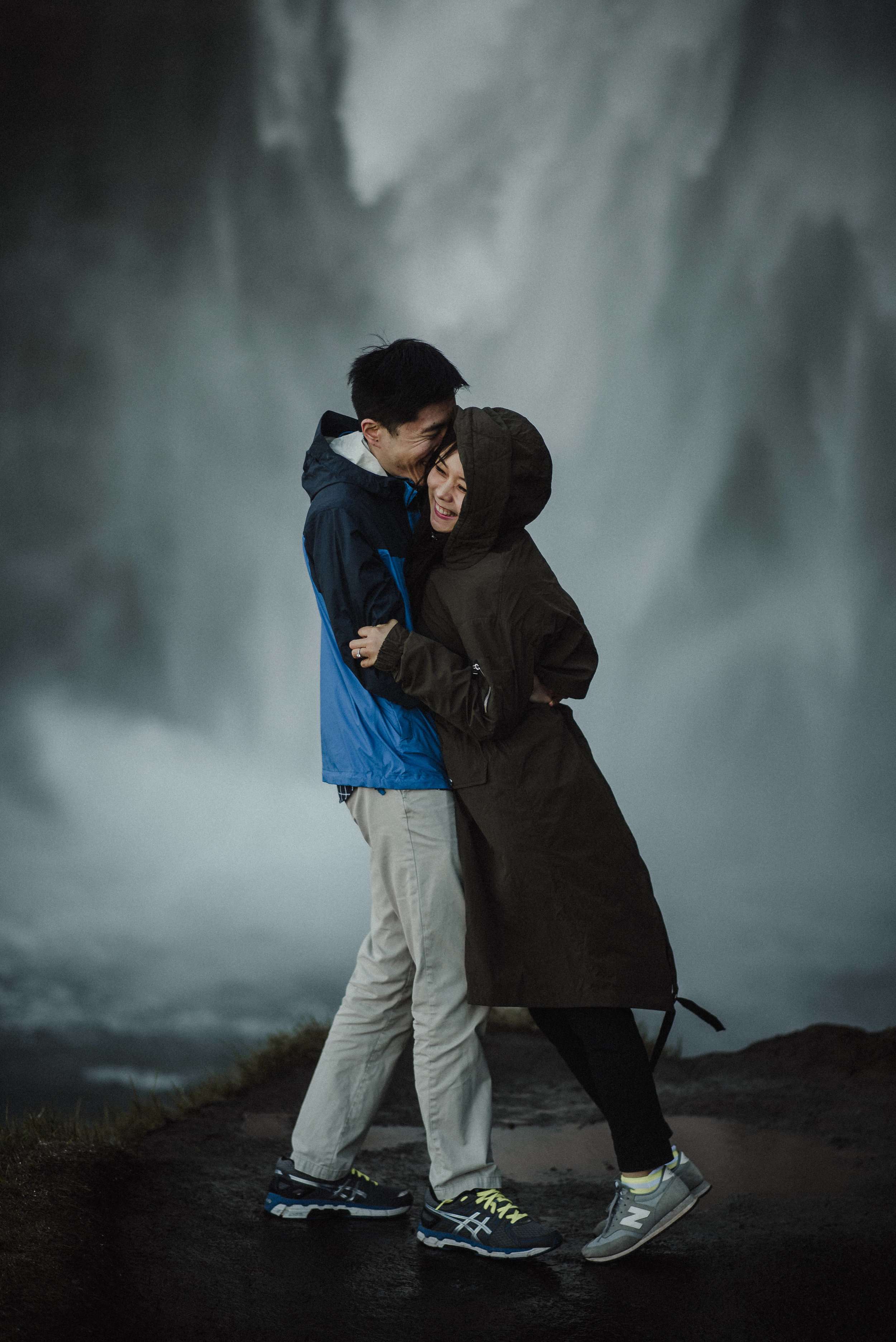 Couple behind waterfall