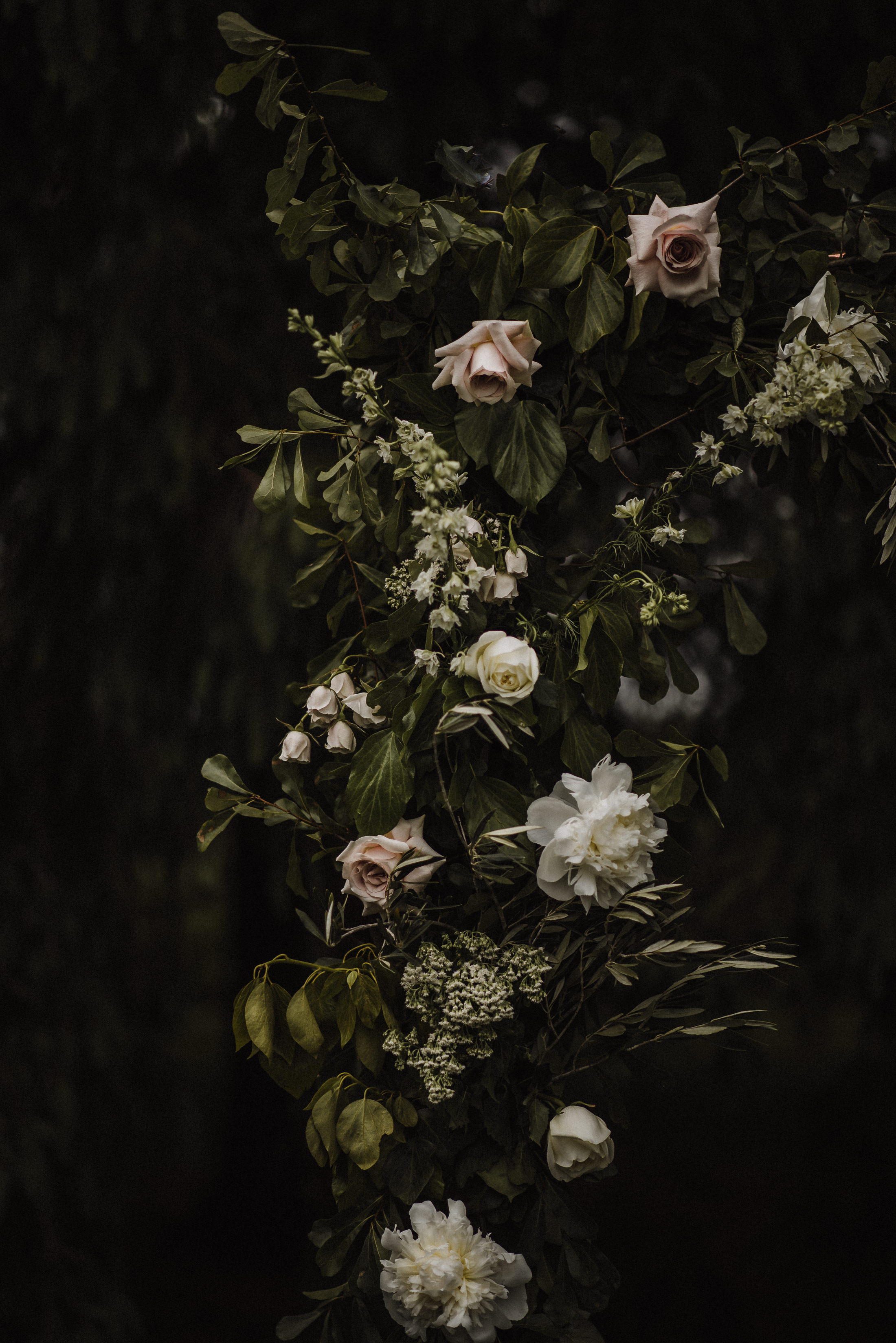 moody ceremony floral backdrop