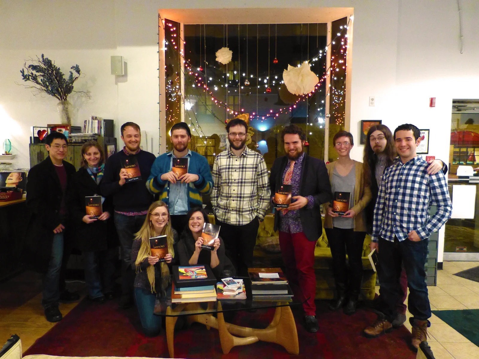 Center, Author Matt Seidel. Group holding the new release of his thriller novel, Saviors. Holon Publishing "Wine & Sign" event from early 2014. 