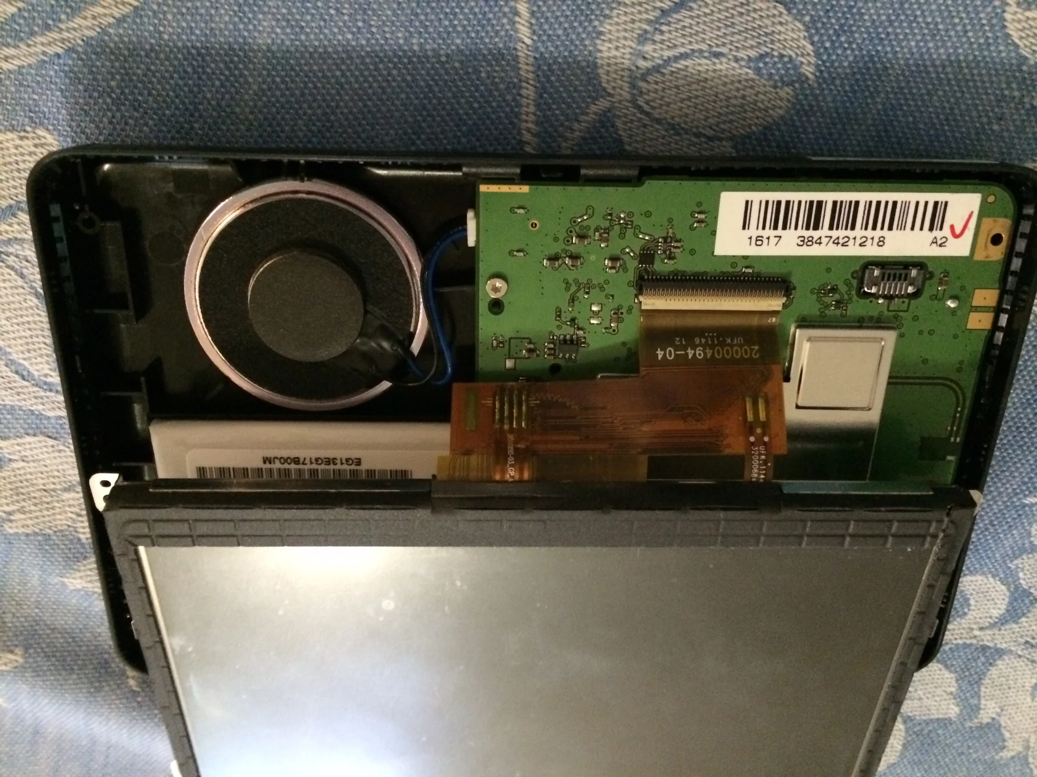 Note the Torx screw between the ribbon and the wire to the speaker.