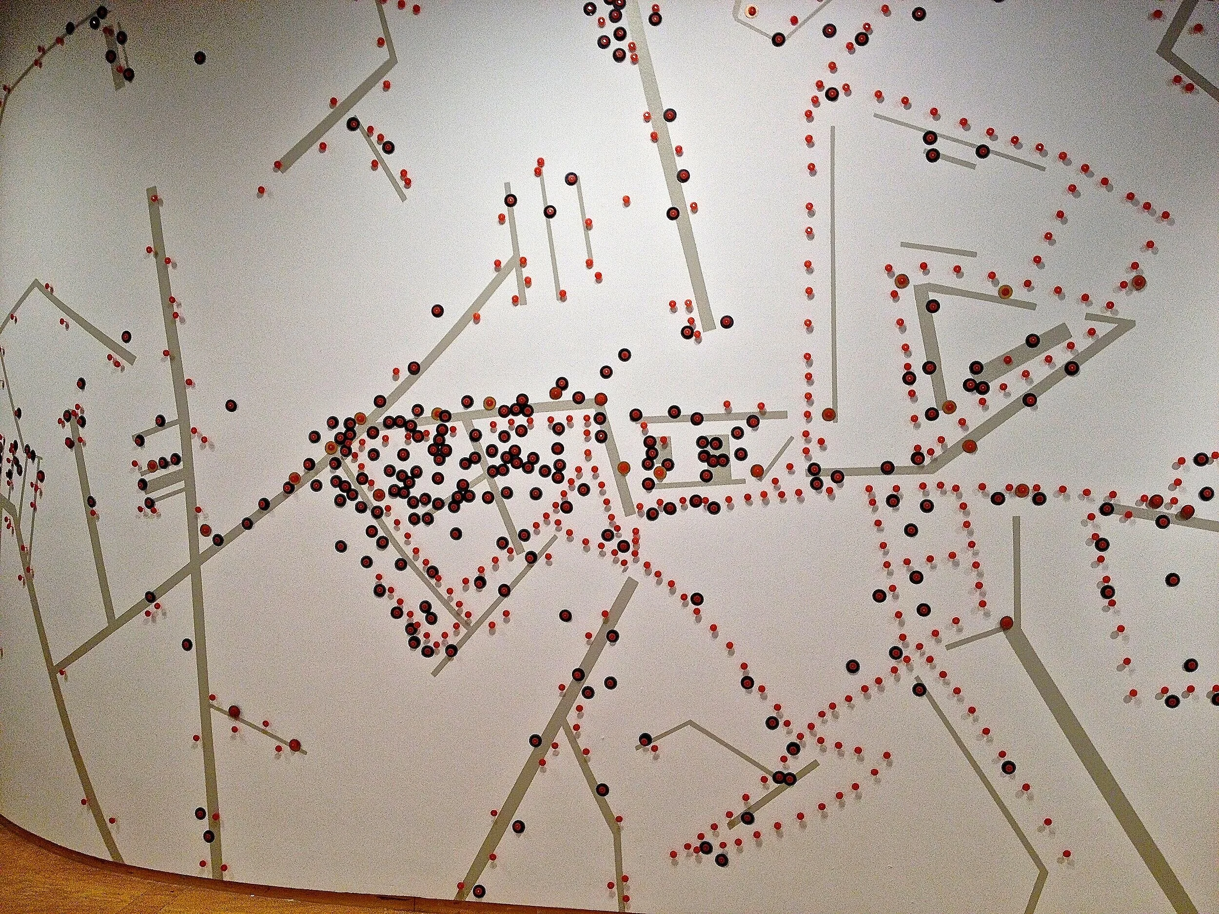 Orange: Crime Dots, 2012, installation view, tin/plastic discs, spray paint and nails