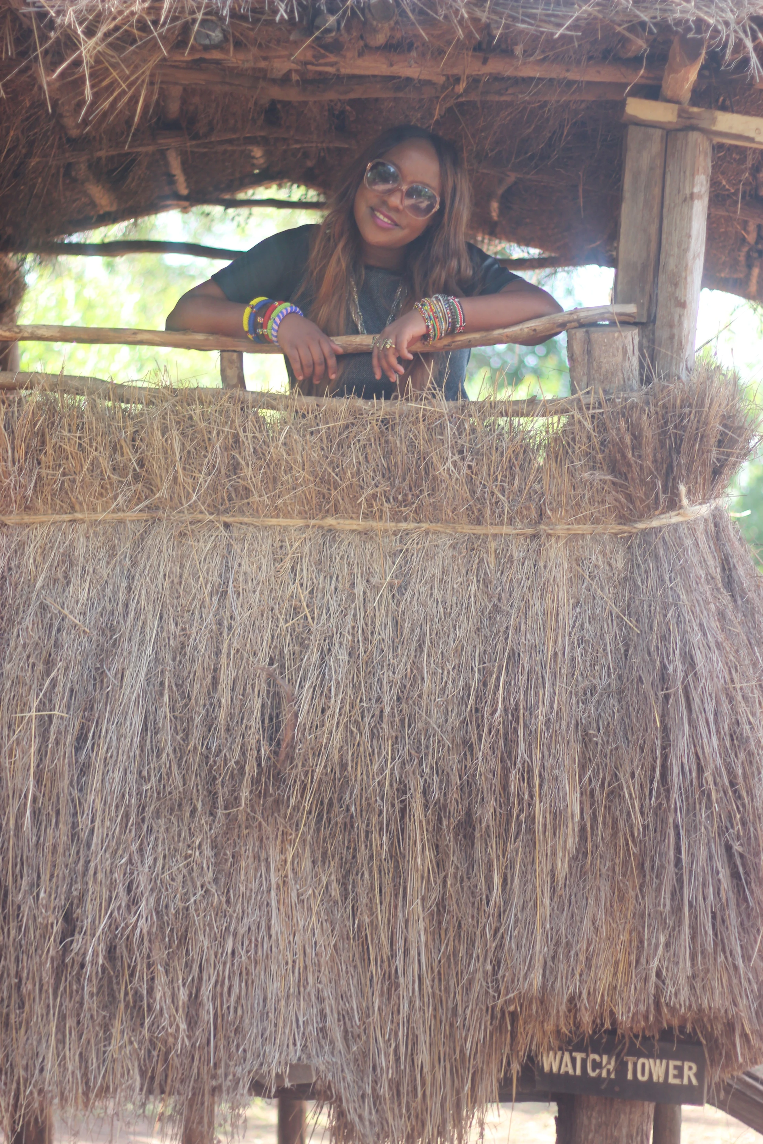 Peeking out through a watch tower of the Mijikenda Boma.