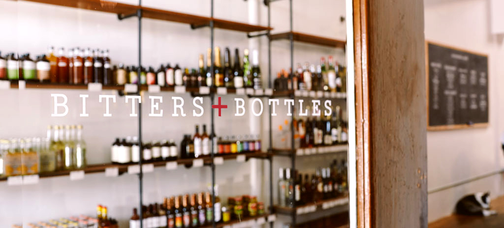Window signage for the Bitters + Bottles South San Francisco Liquor Shop