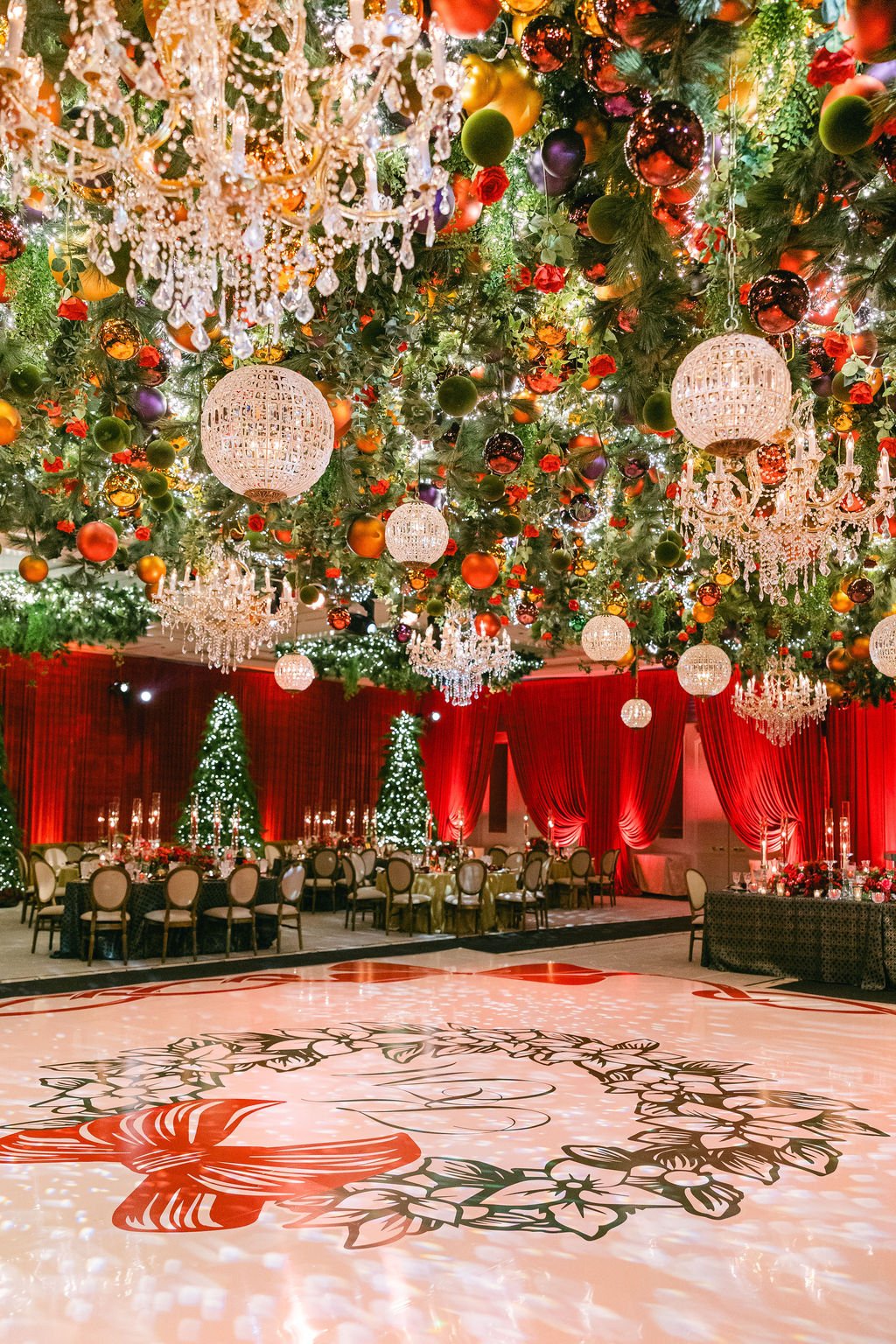 Four Seasons Chicago ballroom decorated for a Christmas wedding with hanging floral installation and christmas trees
