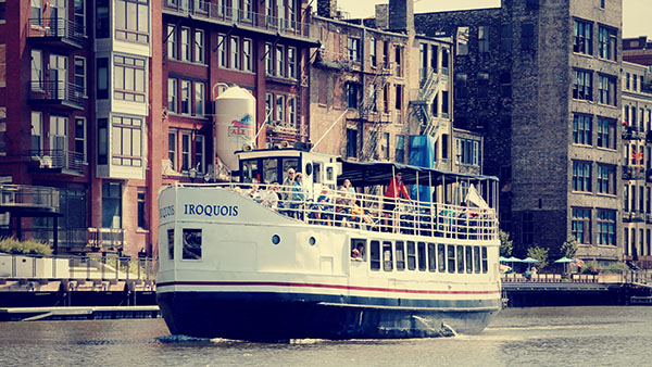 IROQUOIS on Milwaukee River with Historic Third Ward in background.