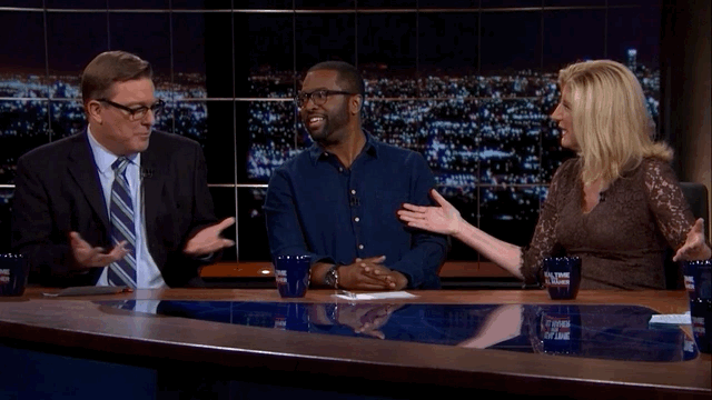 Baratunde lightly gestures at Arianna Huffington then fist bumps Matt Welch on the teevee