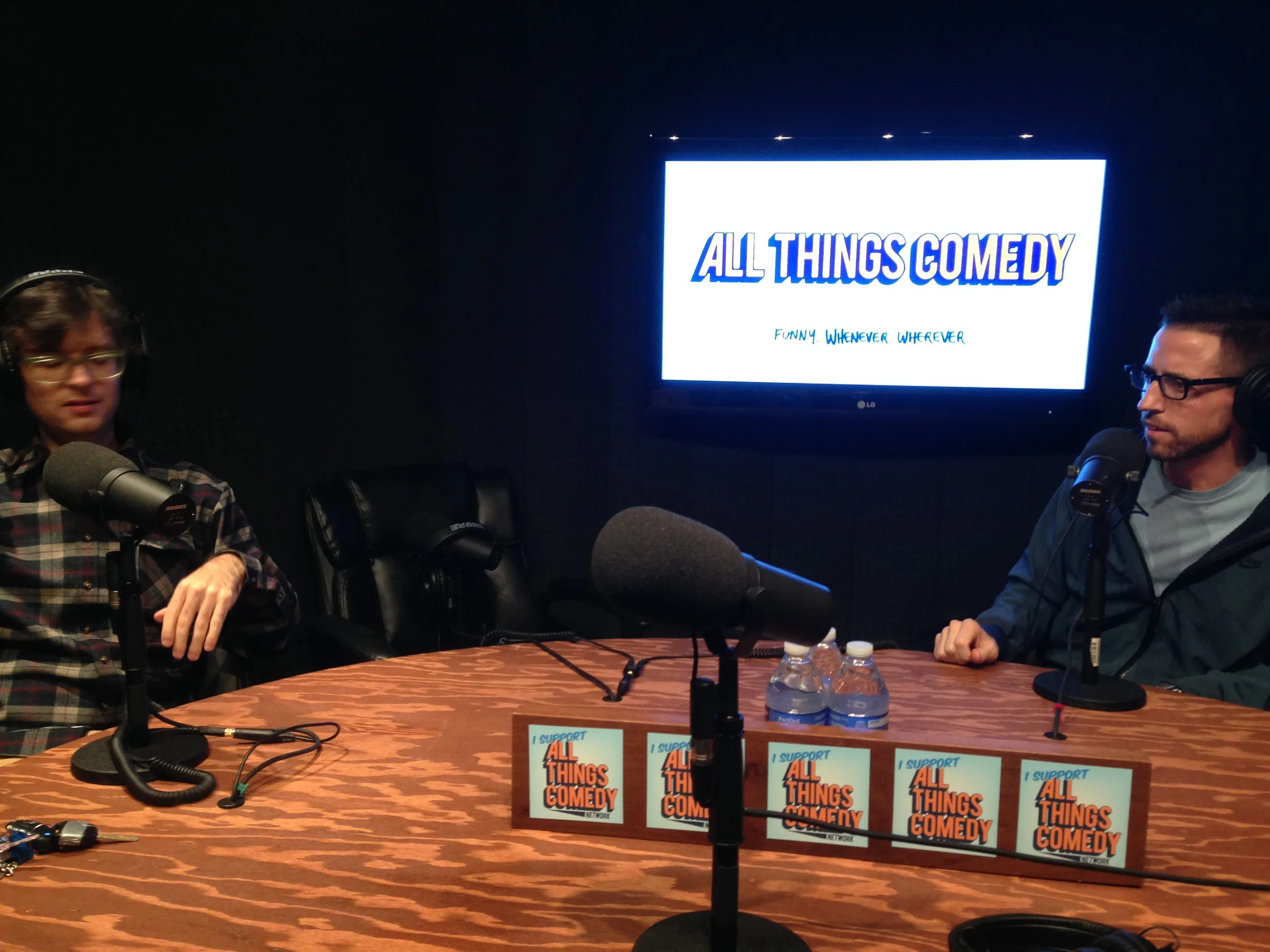 Left: Moshe Kasher. Right: Neal Brennan. Center: Some technology.&nbsp;
