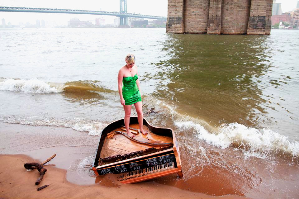 Performance artist Killy Mockstar and the East River Piano. (Photo Credit:Craig Schober) 