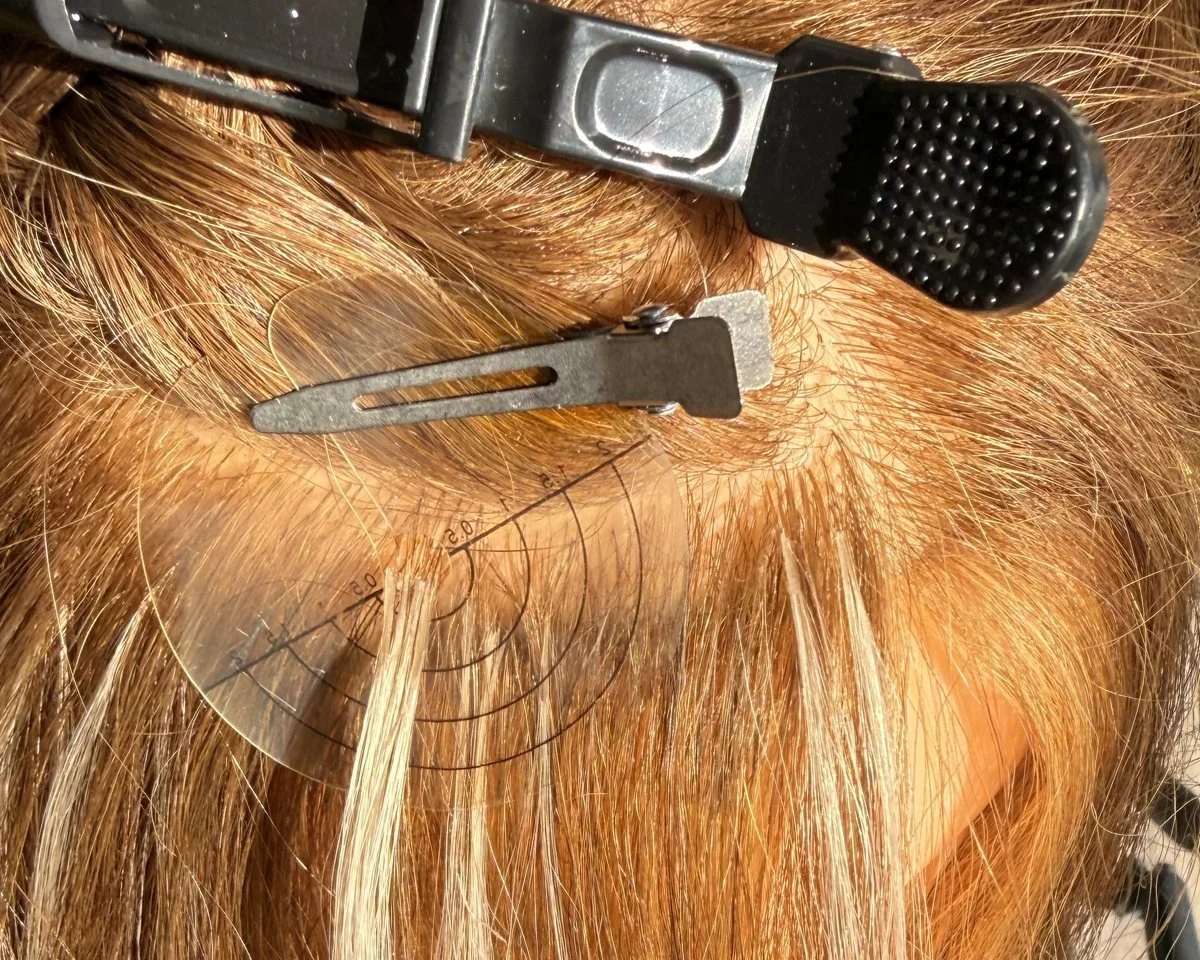 Scalp shield isolating a small section of hair for V-light extension bonds