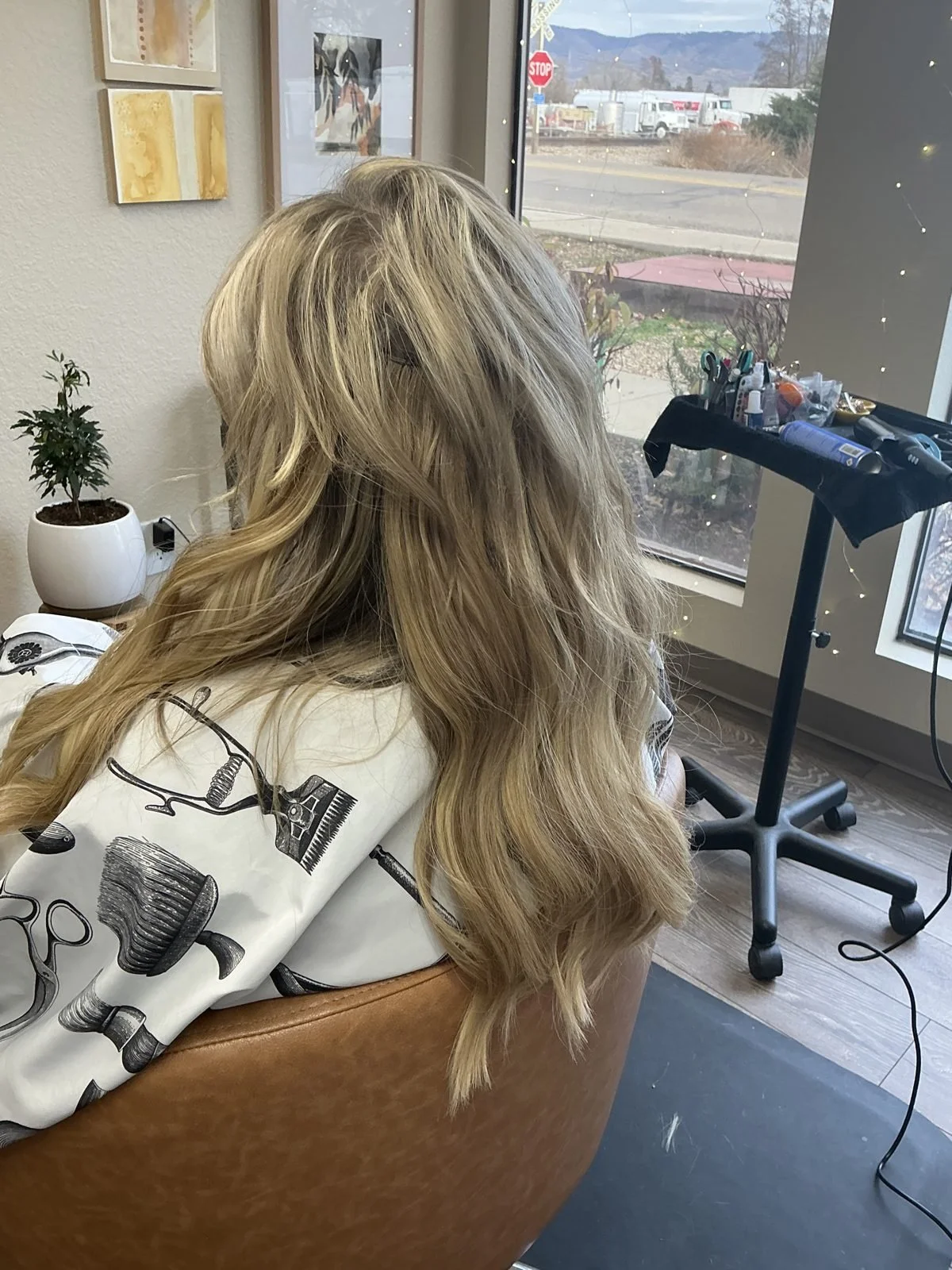After hair extensions, long wavy blonde hair blended with extensions in Boise, Idaho