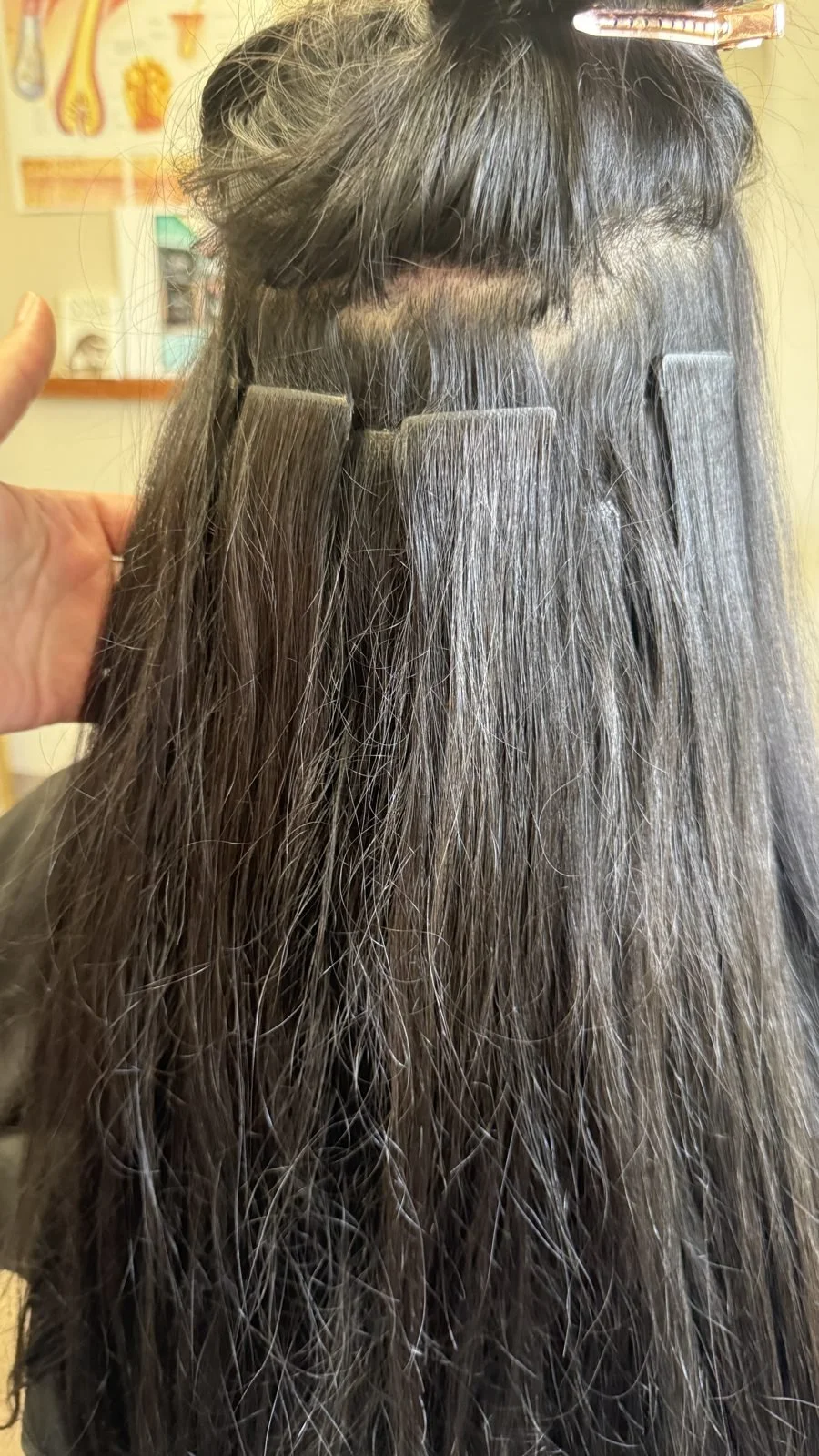 Tape-in hair extensions installed on dark brown hair with gray at Fusion Studio in Boise