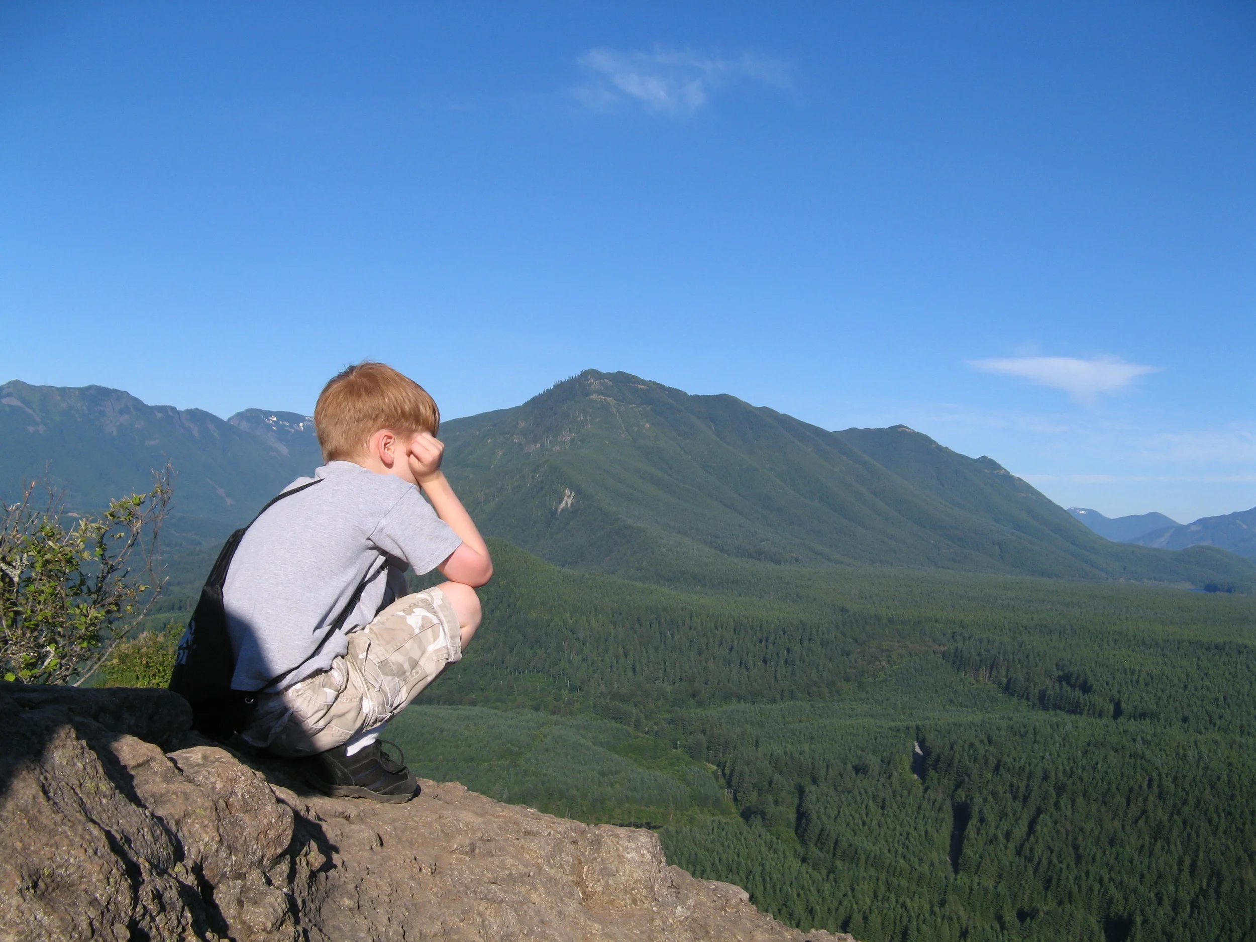 Boy #3 looking out over the great expanse of the Cascades from Rattlesnake Ledge just east of Seattle.