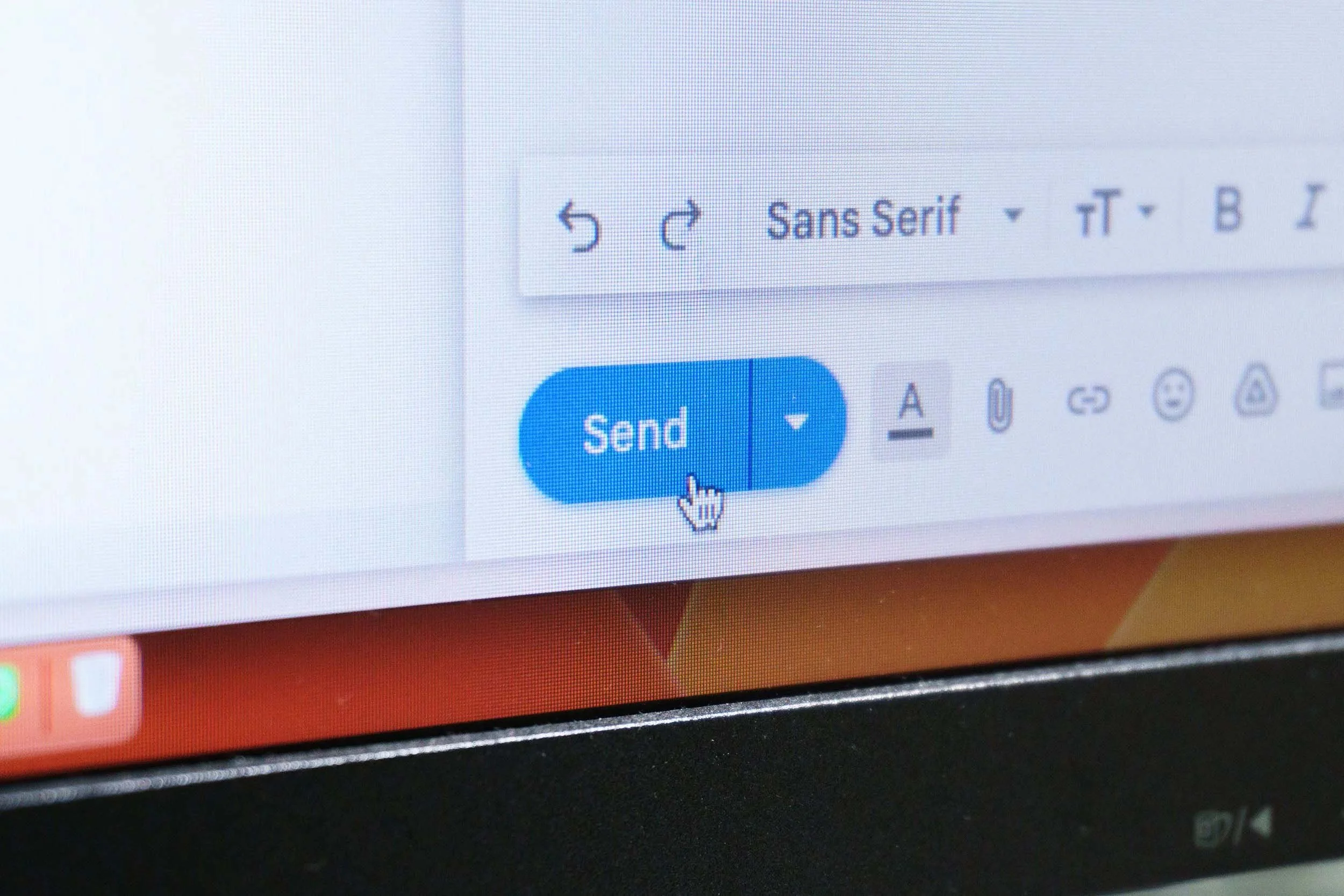 A computer screen displaying an email compose window with a blue 'Send' button and various formatting options.