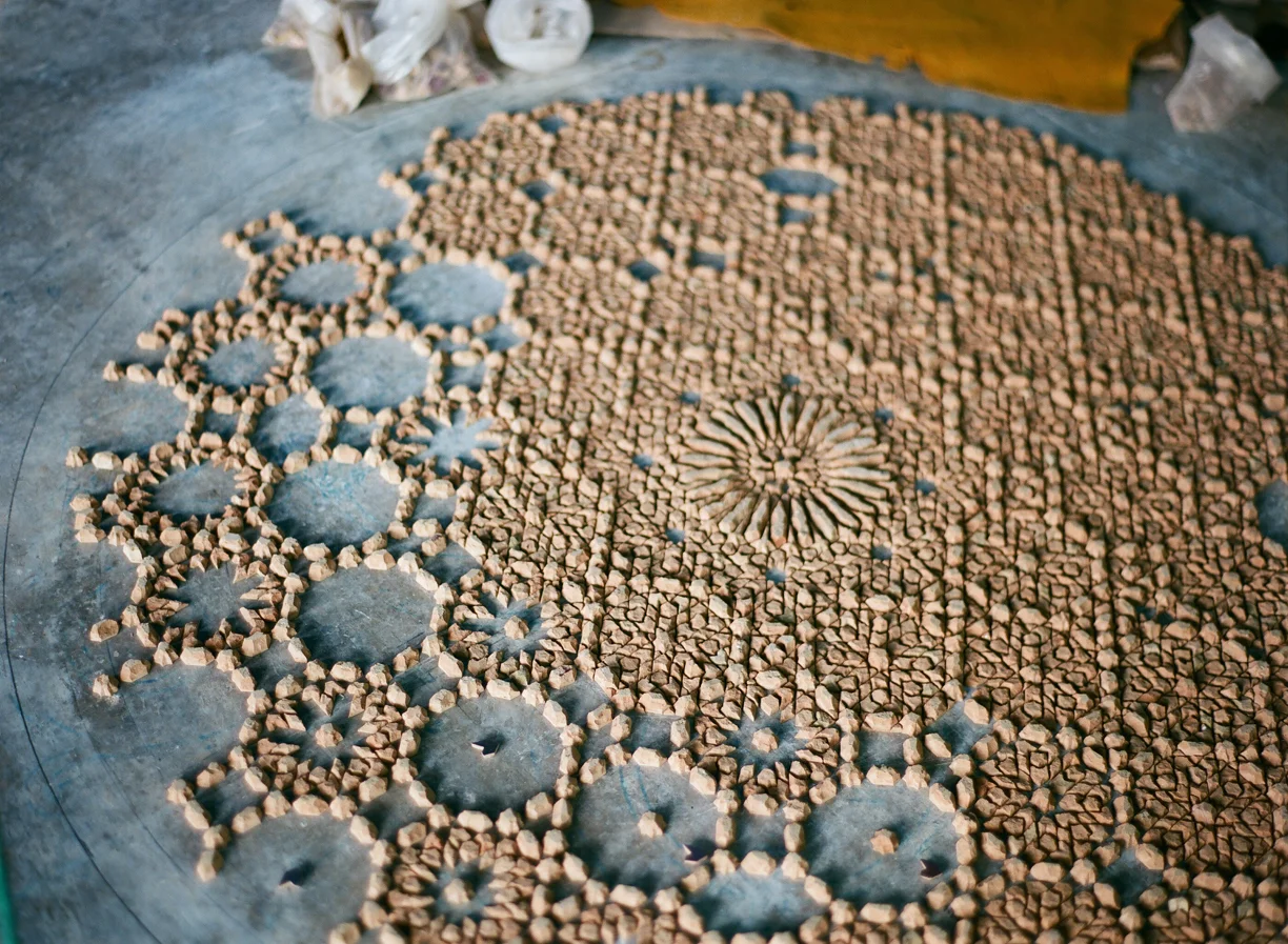 tile pieces laid out in circle on floor_fez co-op_web.jpg