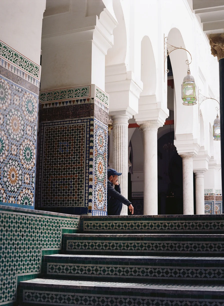 Man Seated on Tiled Floor Inside Mosque_Fez_web.jpg